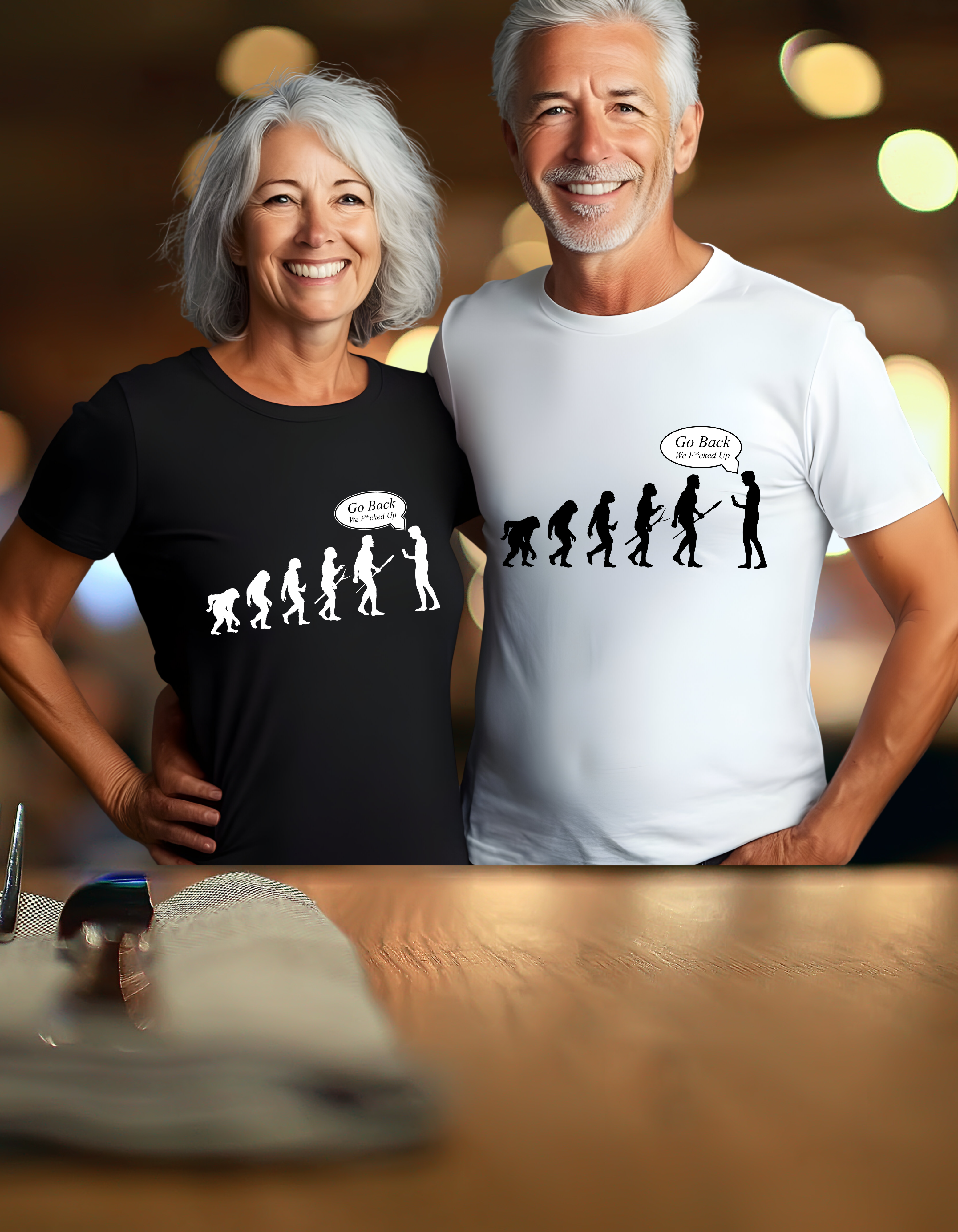 Couple wearing humorous evolution-themed t-shirts with evolution graphic, standing together indoors.