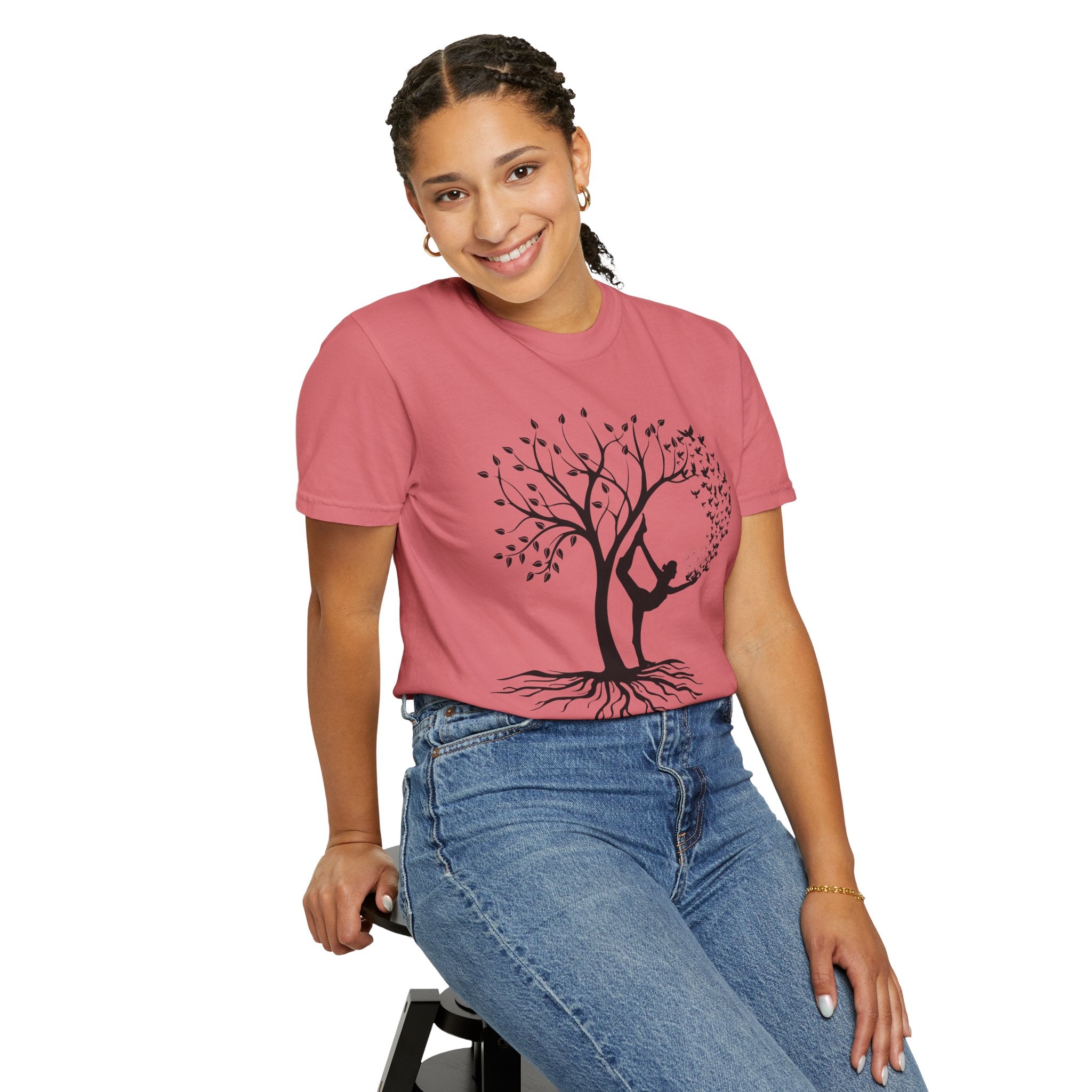 Woman wearing a yoga graphic tee with a tree and yoga pose design, ideal for meditation and mindfulness.
