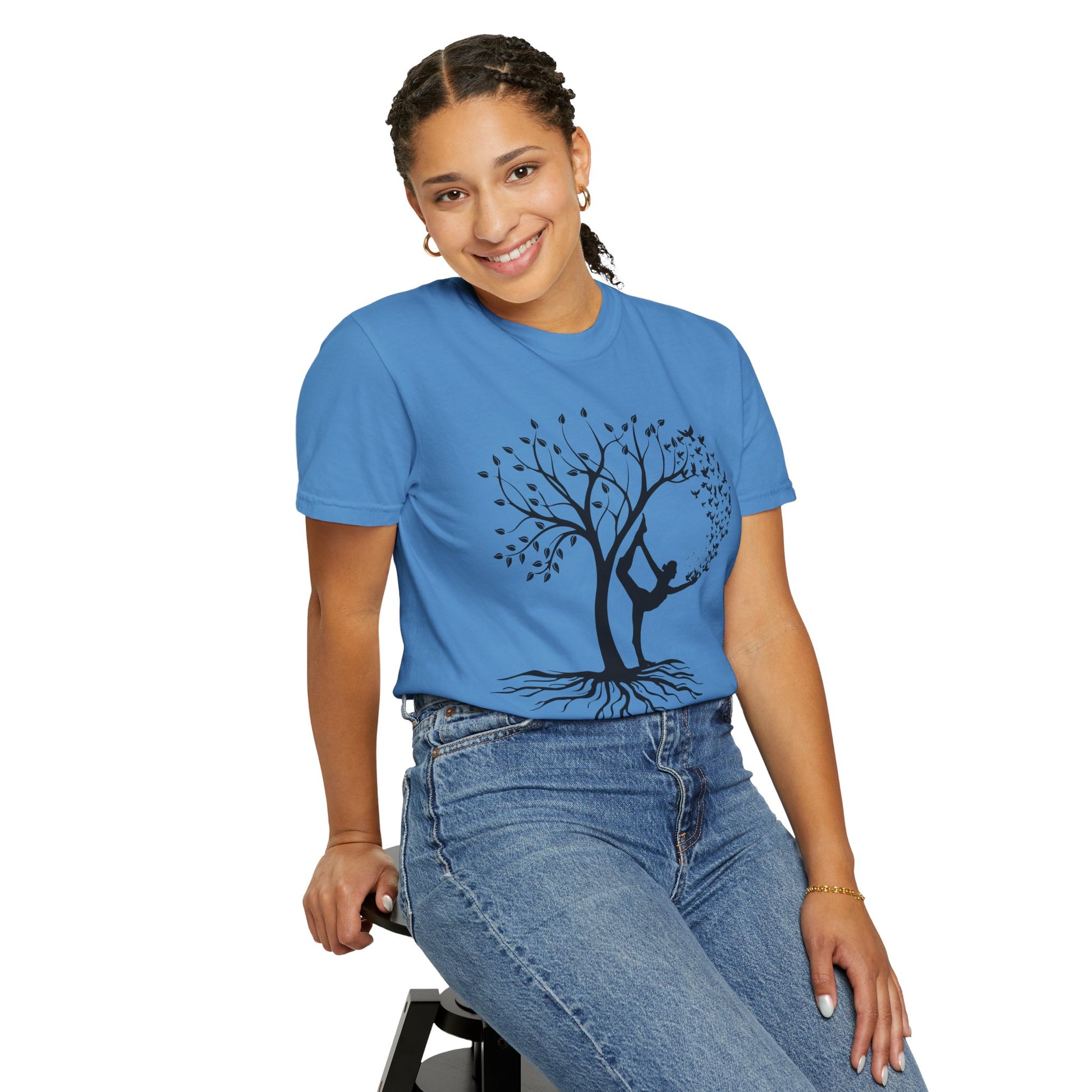 Woman wearing a blue yoga graphic tee with tree design, embodying calm and positivity.