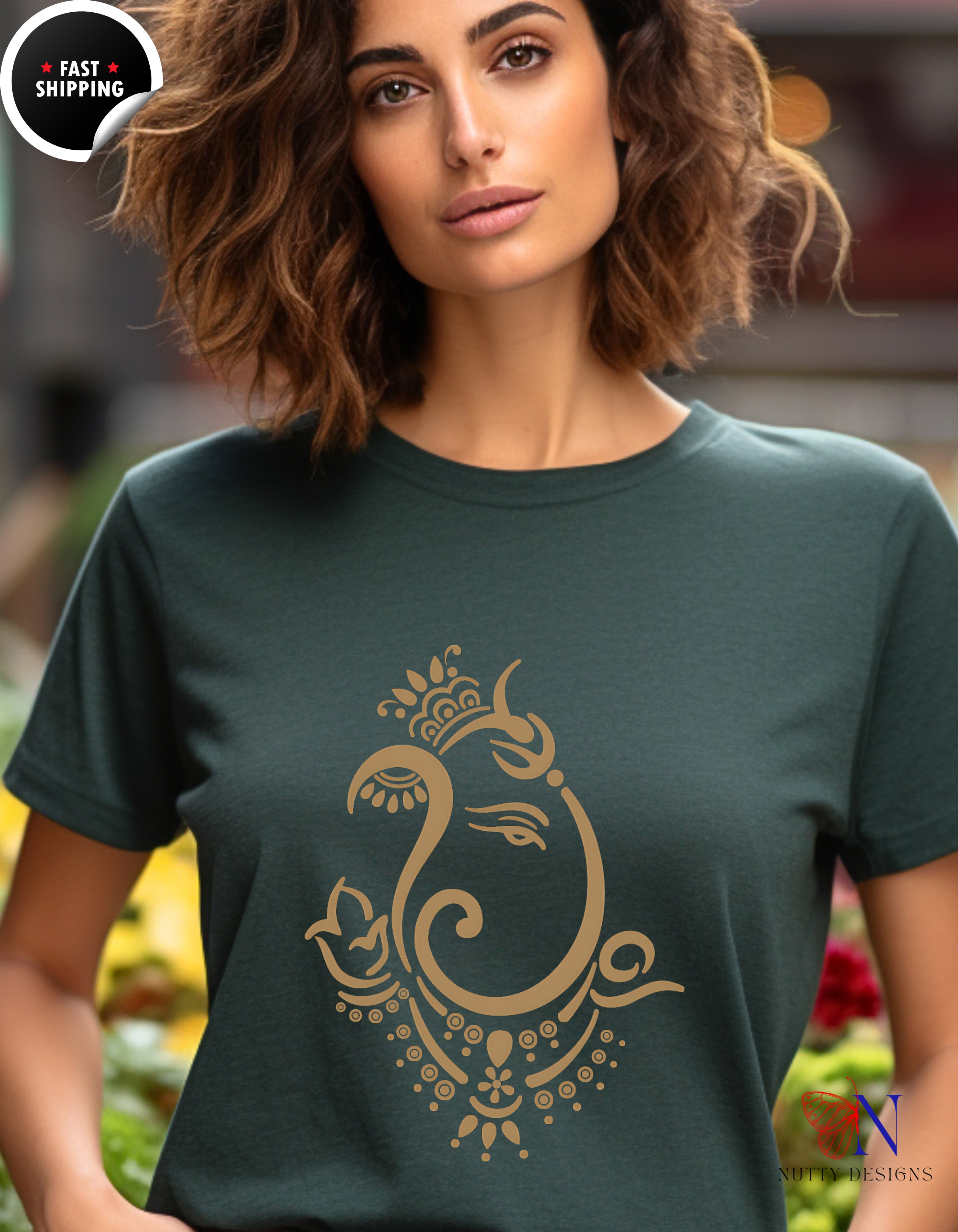 a woman wearing a green t - shirt with a gold peacock on it