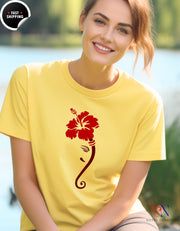 a woman wearing a yellow shirt with a red flower on it