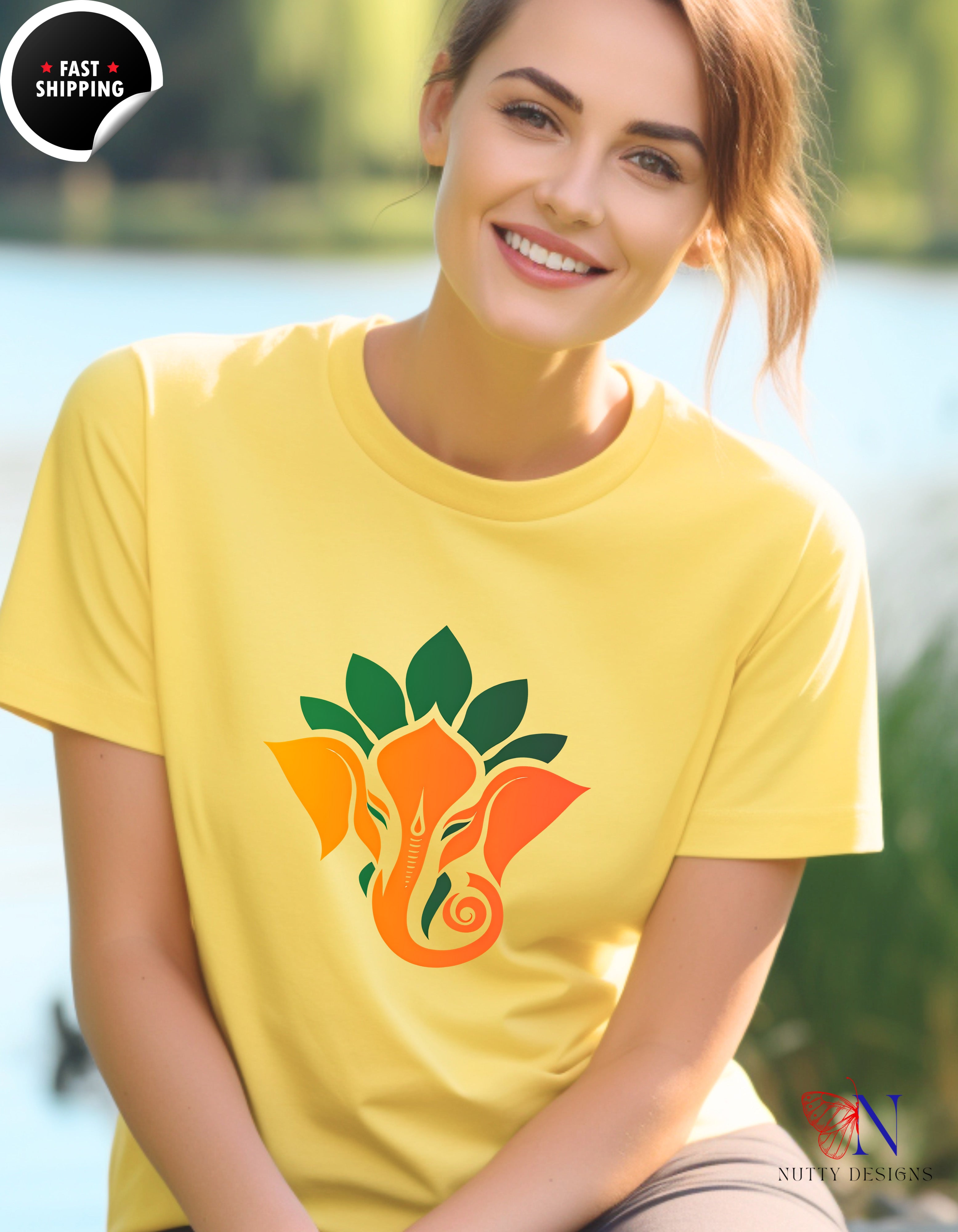 a woman wearing a yellow t - shirt with an elephant on it