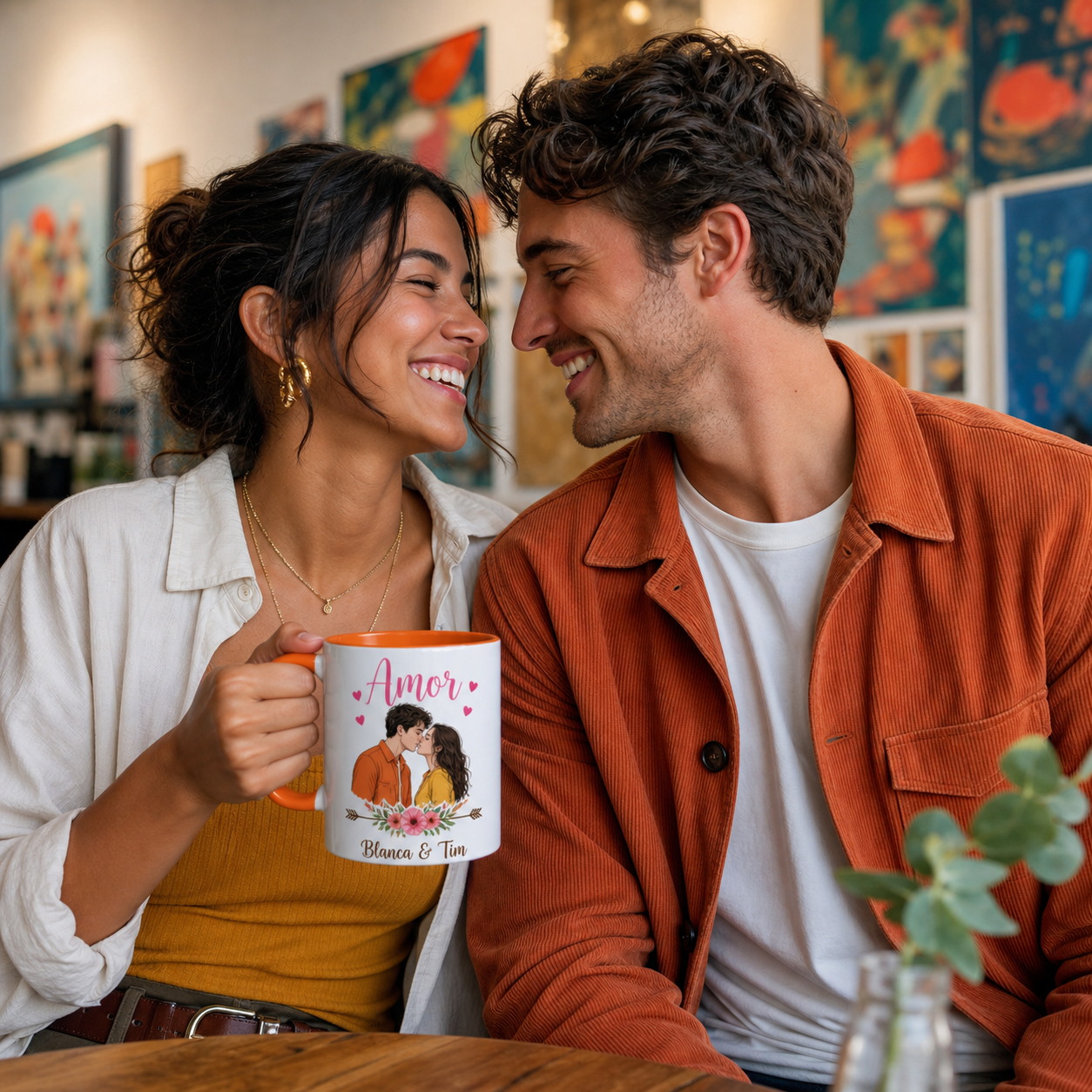Young couple holding personalized orange-accent Amor mug in an art gallery cafe