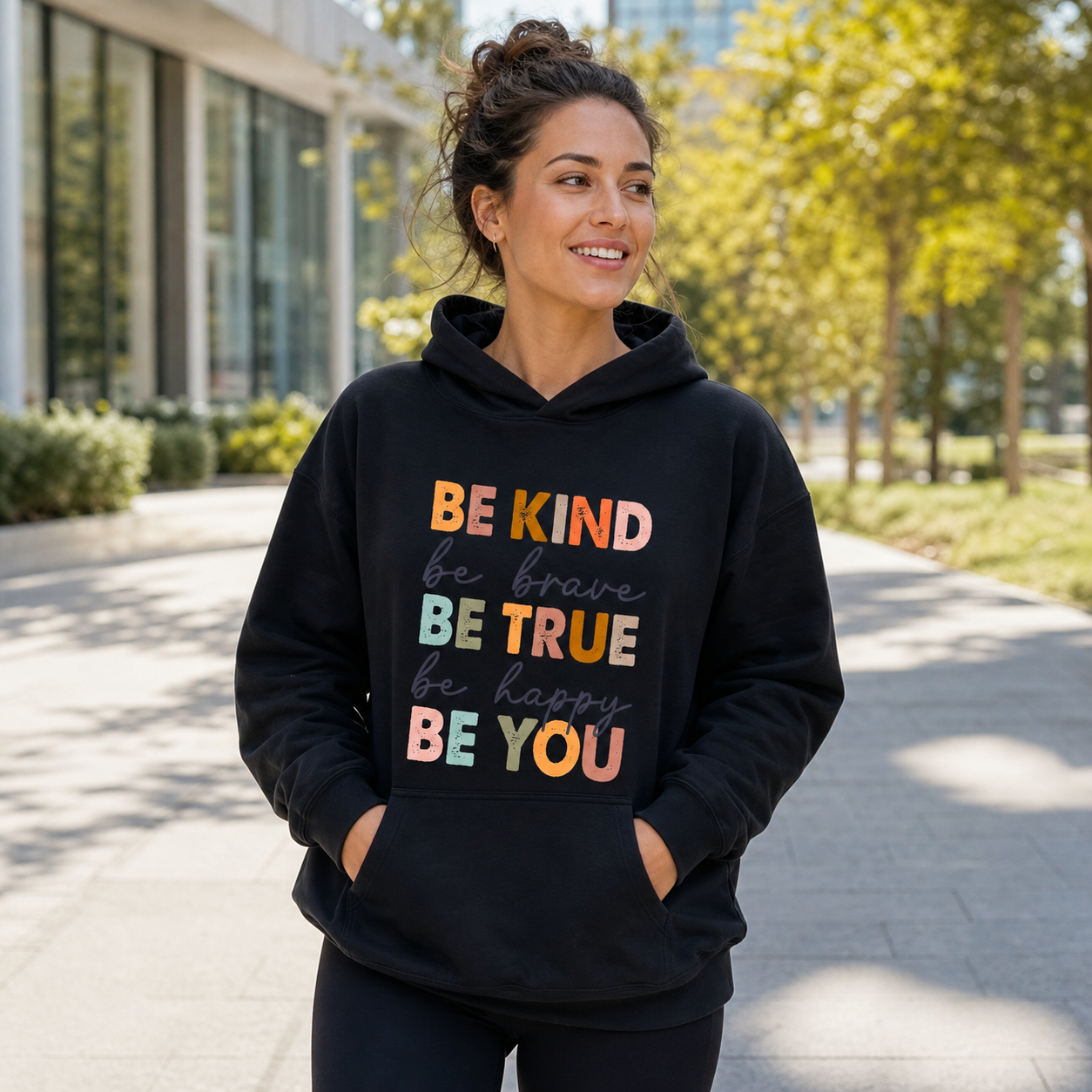 Woman wearing Be Kind Be Brave Be True inspirational black hoodie outdoors