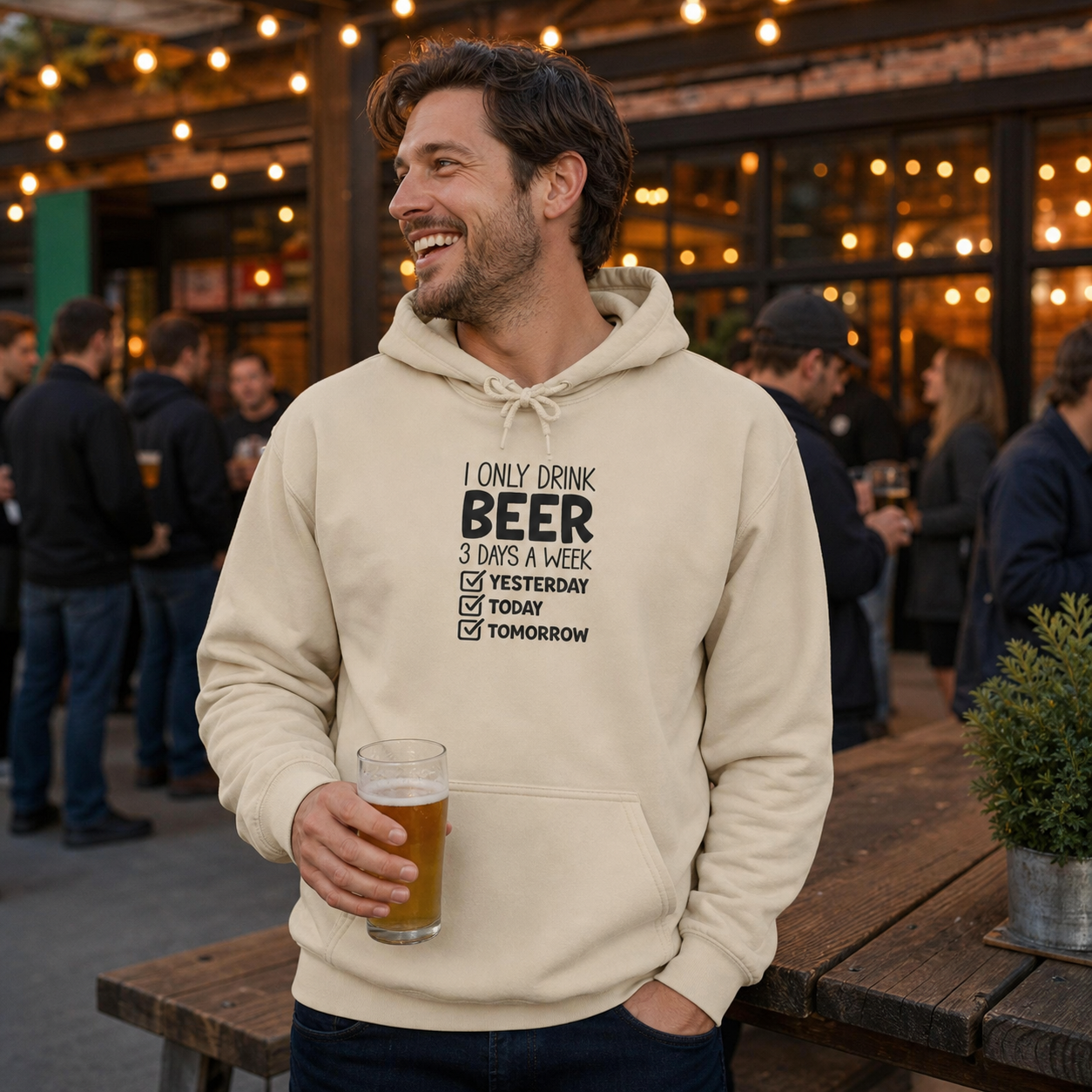 Man wearing funny Beer Checklist hoodie while relaxing with a beer at home