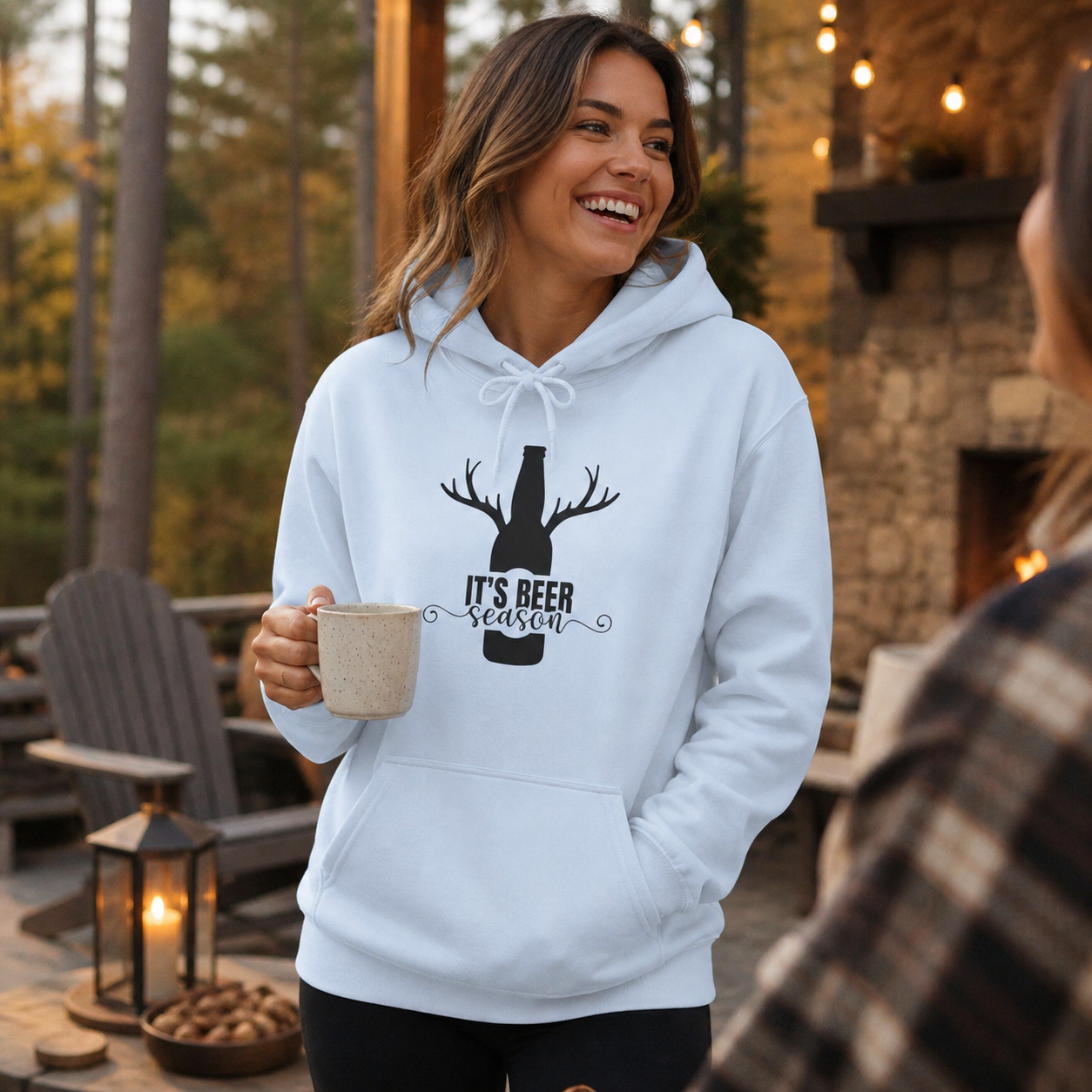 Woman wearing Beer O'Clock antlers graphic hoodie in an outdoor lifestyle setting