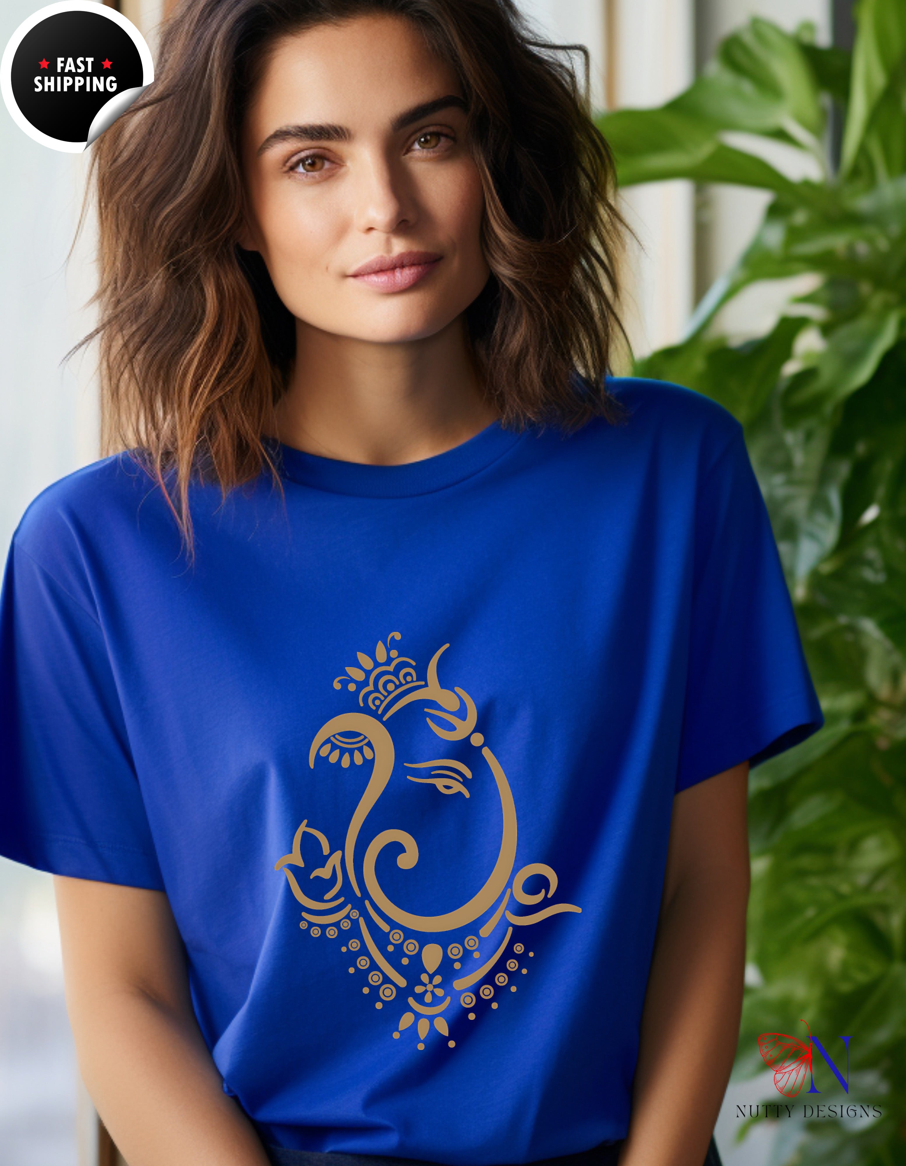 a woman wearing a blue t - shirt with a gold peacock on it