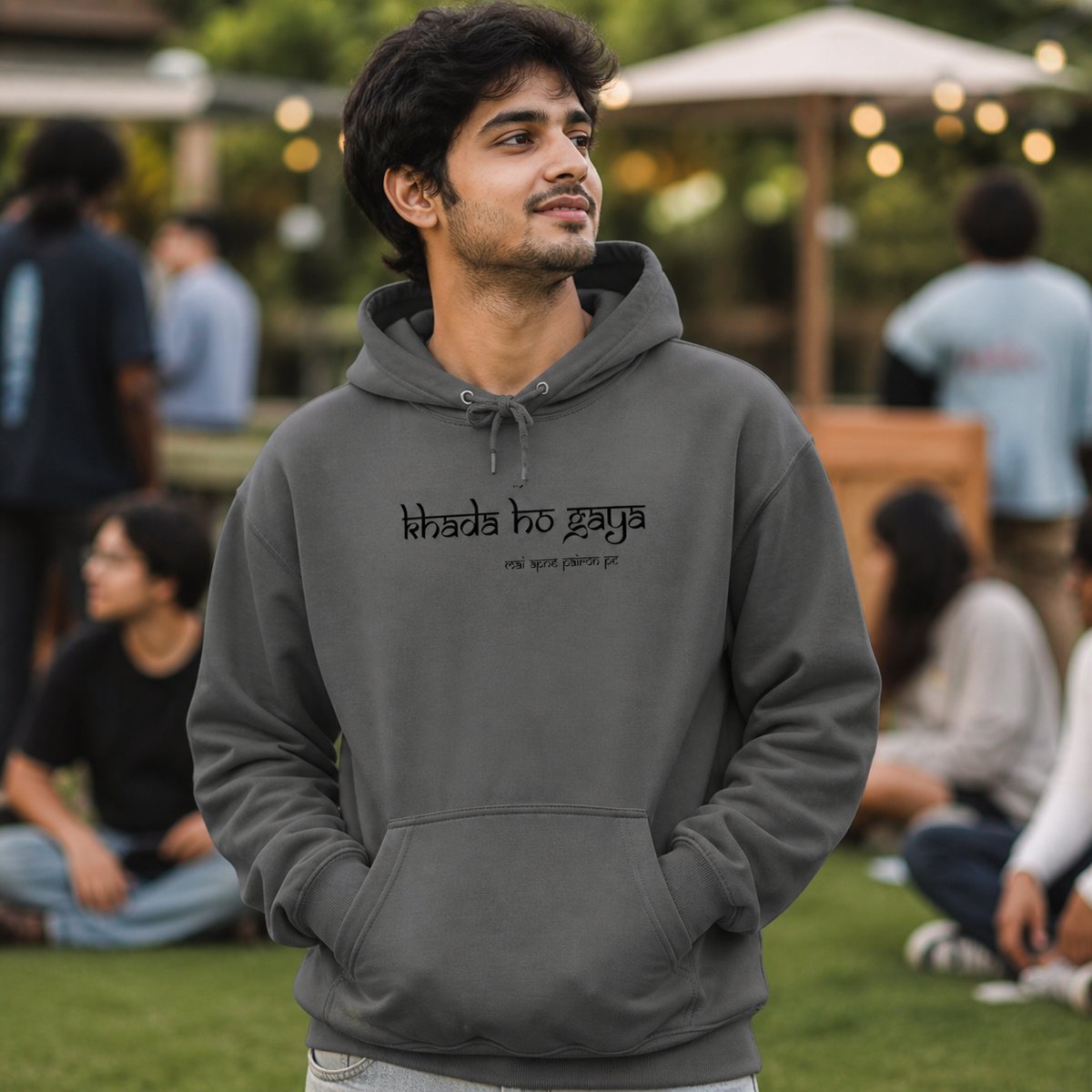 Young Indian man wearing charcoal Lo Khada Ho Gaya graphic hoodie outdoors — alternate clean view