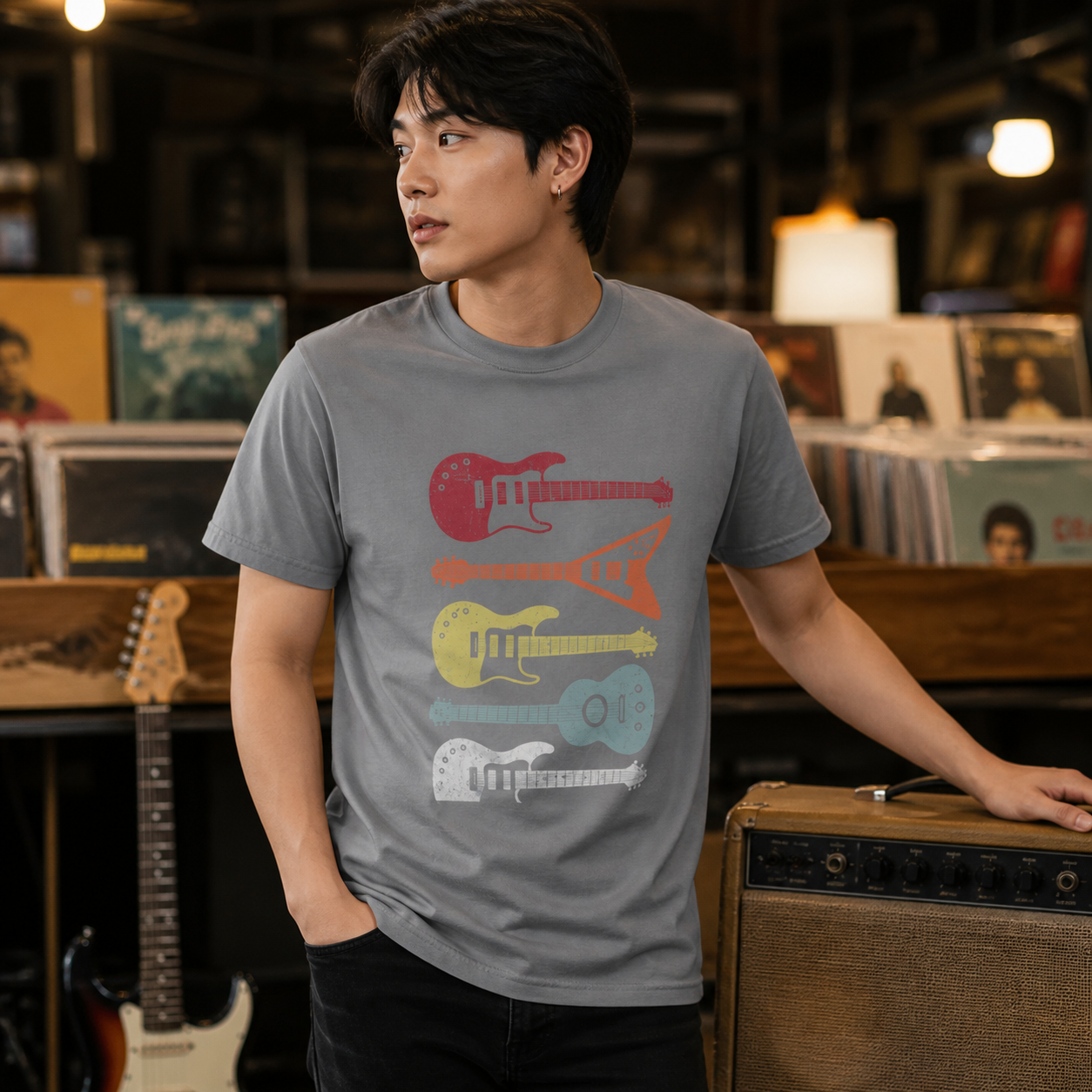 Young musician wearing retro stacked guitar graphic T-shirt in a record shop — alternate clean view