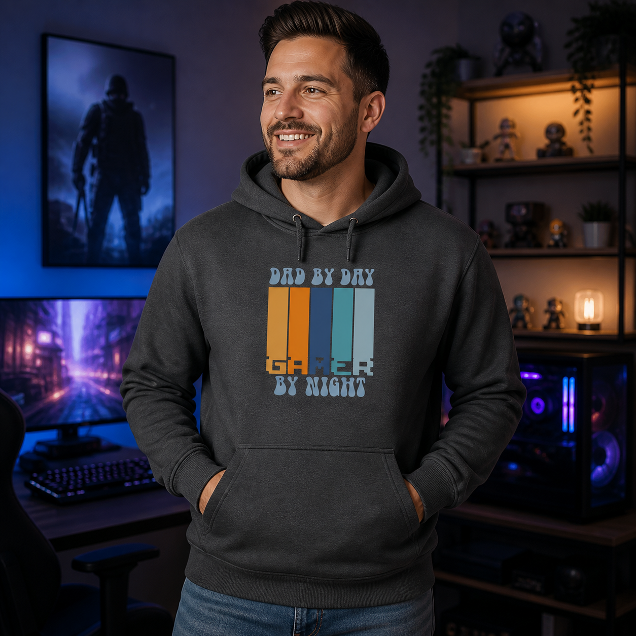 Father wearing Dad by Day Gamer by Night graphic hoodie in a modern gaming room