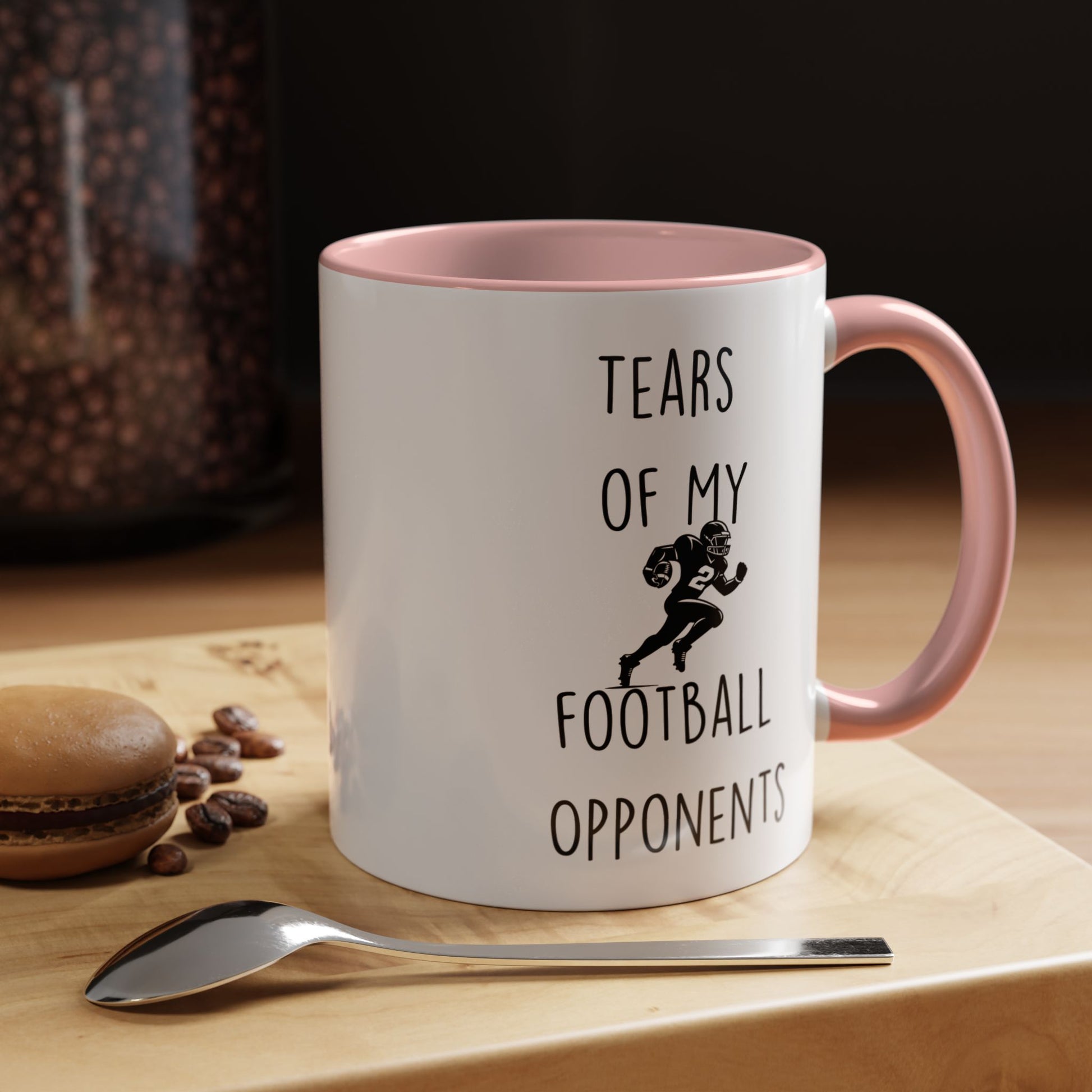 Personalized funny coffee mug with 'Tears Of My Football Opponents' design on wooden table.
