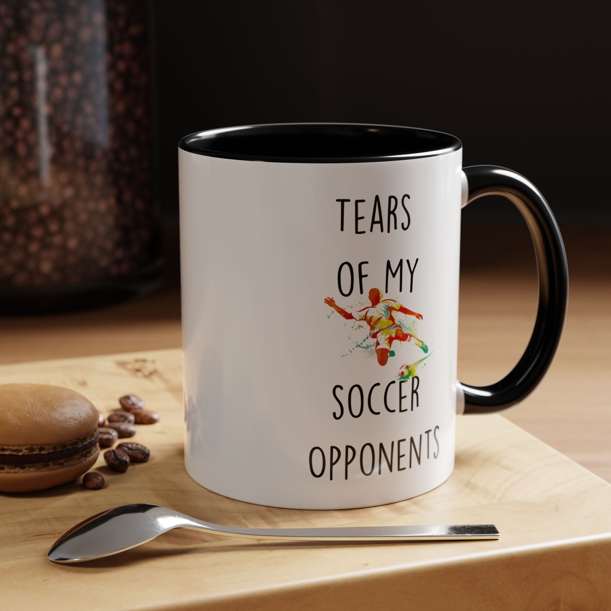 Personalized sarcastic coffee mug, Tears Of My Soccer Opponents Tea Cup, shown on a countertop with spoon and coffee beans