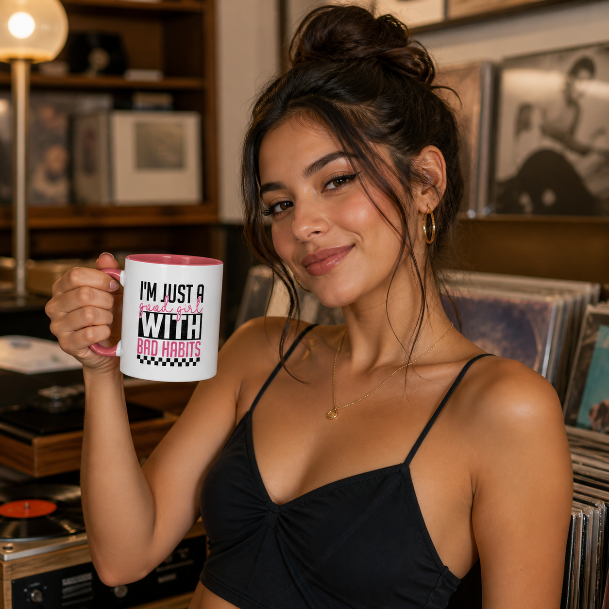 Young woman holding pink-accent Good Girl With Bad Habits mug