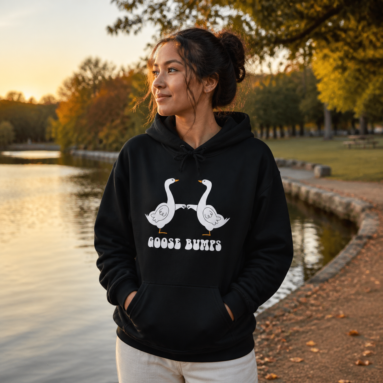 Couple wearing matching Goose Bumps graphic hoodies in a cozy lifestyle setting