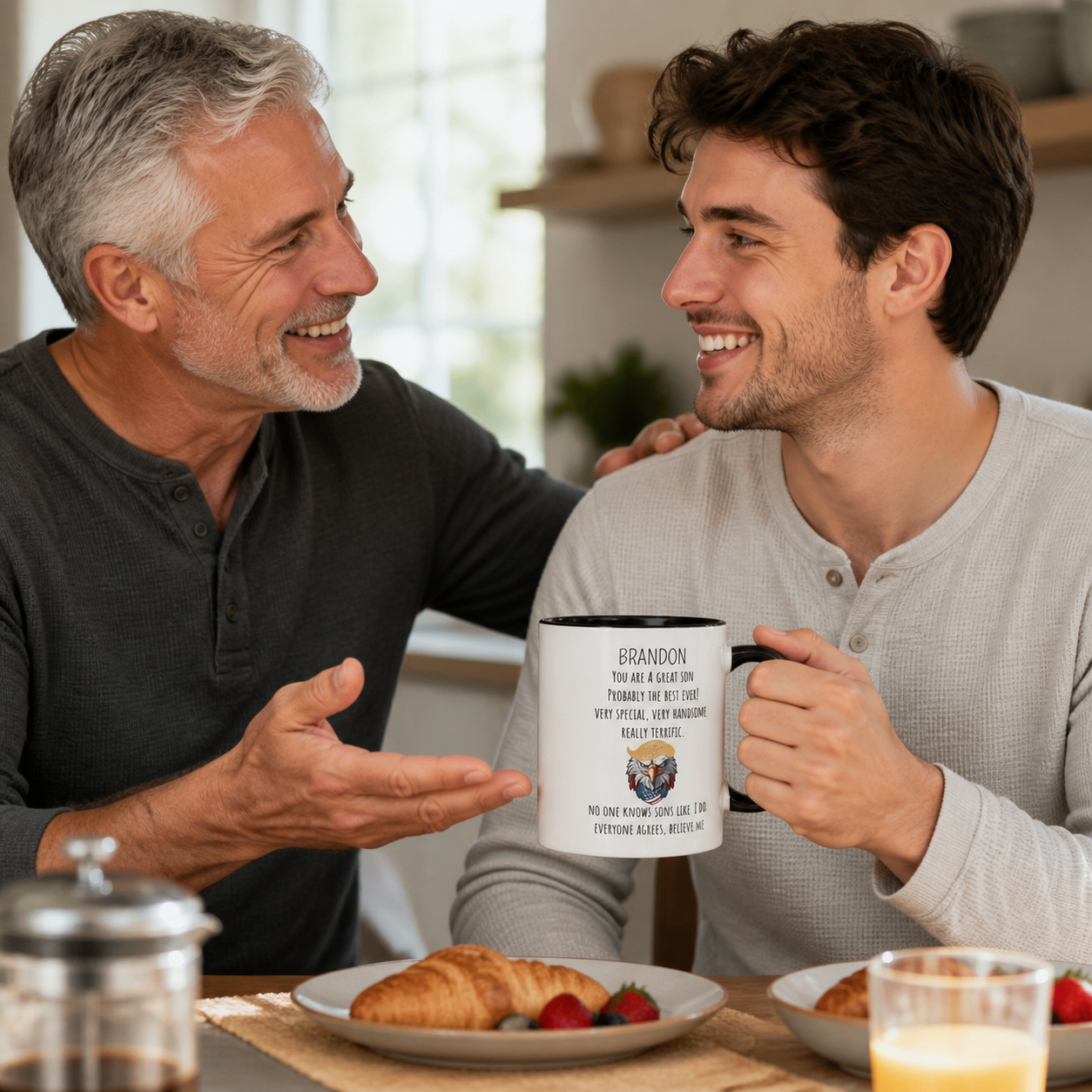 Father and adult son sharing a personalized Great Son black-accent mug at breakfast