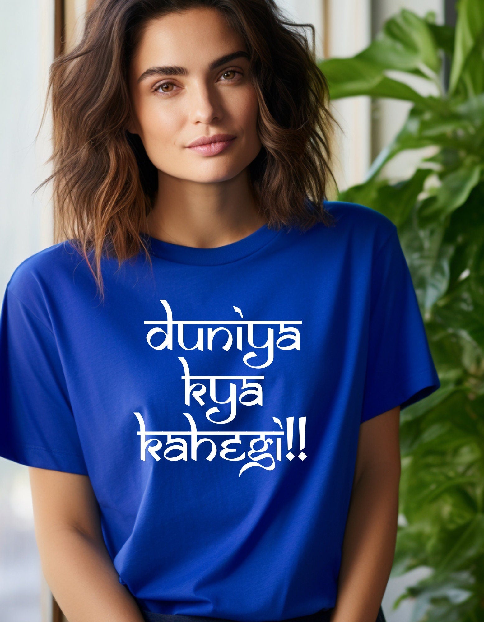 a woman wearing a blue t - shirt that says duniya kya rangeg