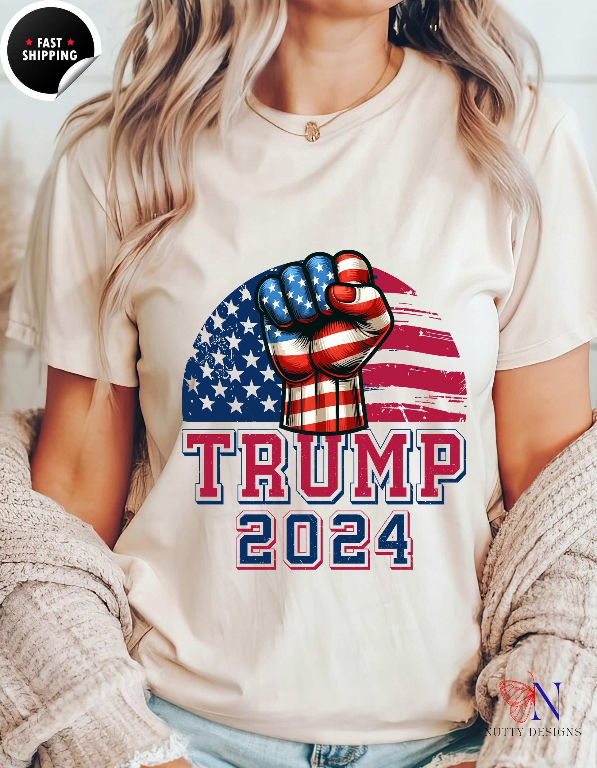 a woman wearing a t - shirt that says trump in a fist