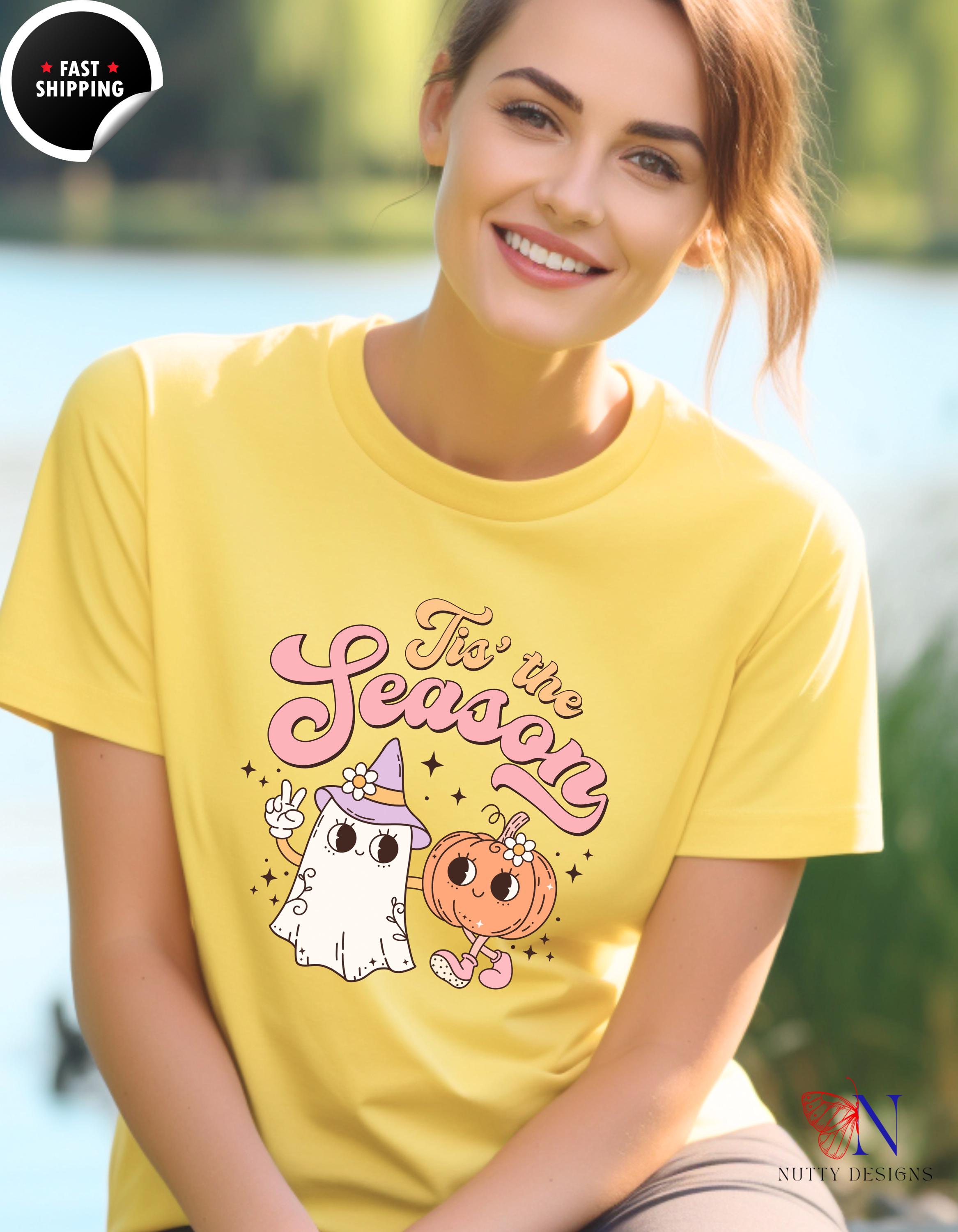 a woman wearing a yellow t - shirt with a ghost on it