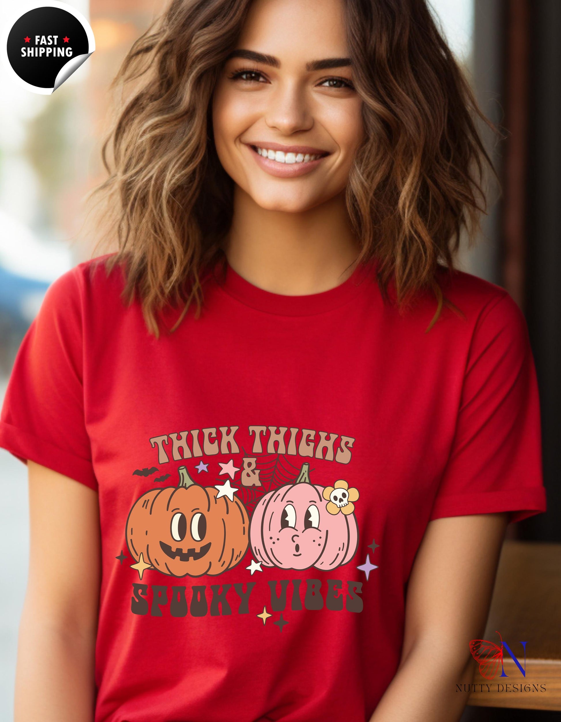 a woman wearing a red shirt with two pumpkins on it