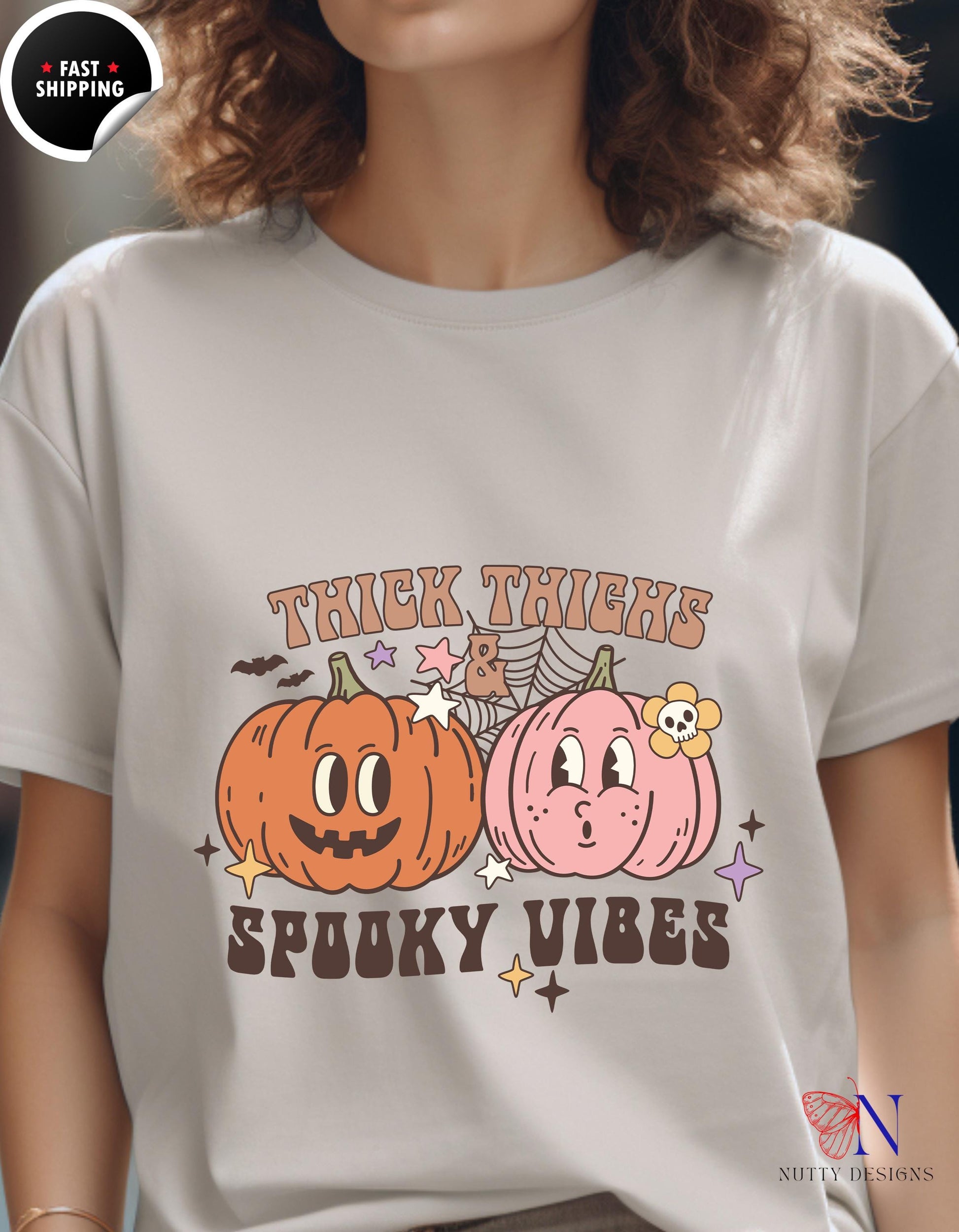 a woman wearing a t - shirt with two pumpkins on it