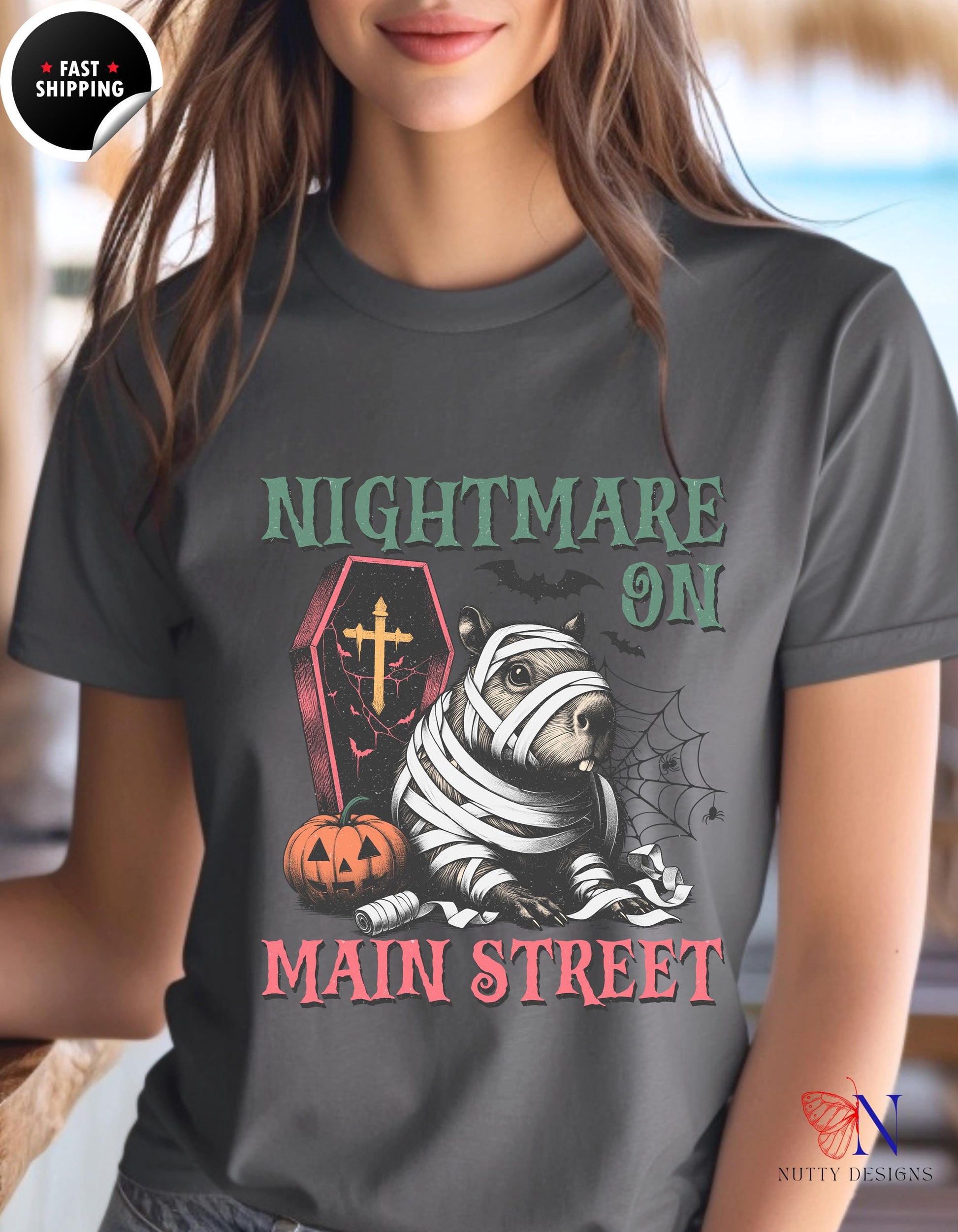 a woman wearing a t - shirt that says nightmares on main street