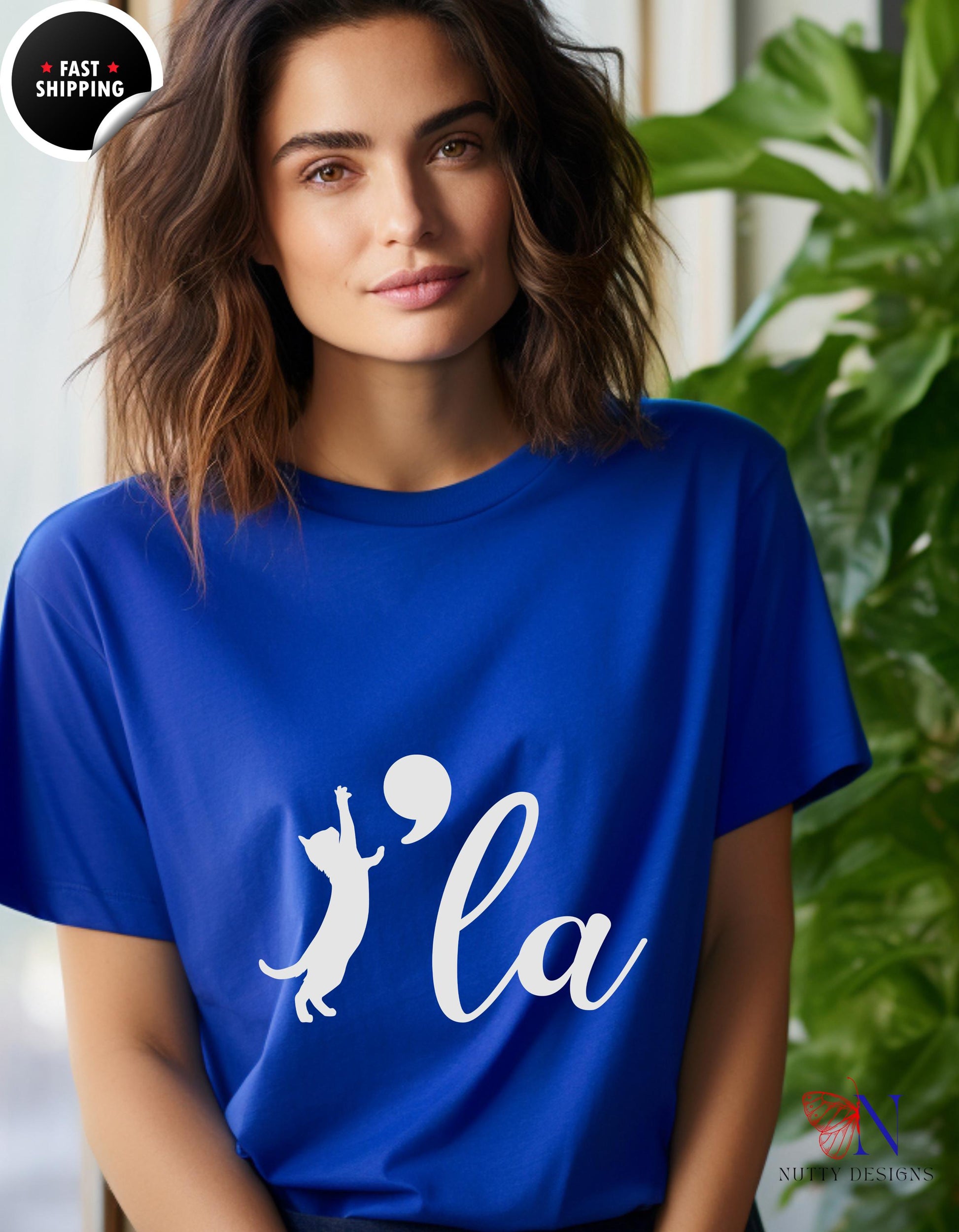 a woman wearing a blue t - shirt with the word la on it