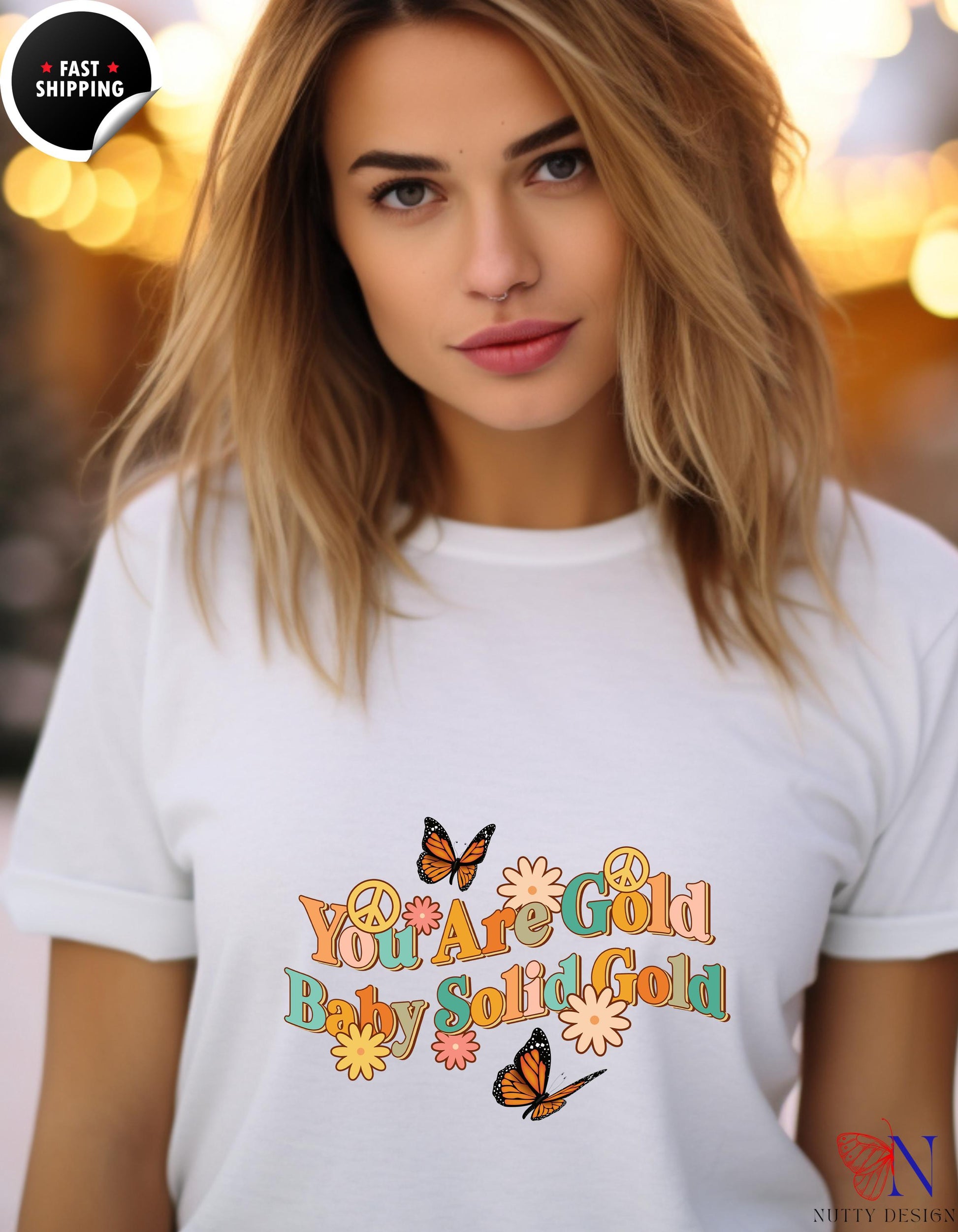 a woman wearing a white shirt with a butterfly on it