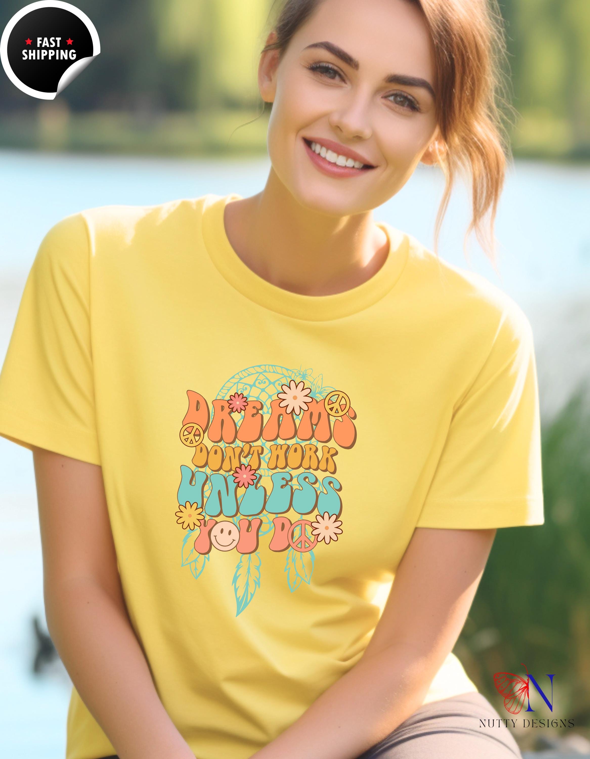 a woman wearing a yellow shirt sitting on a bench