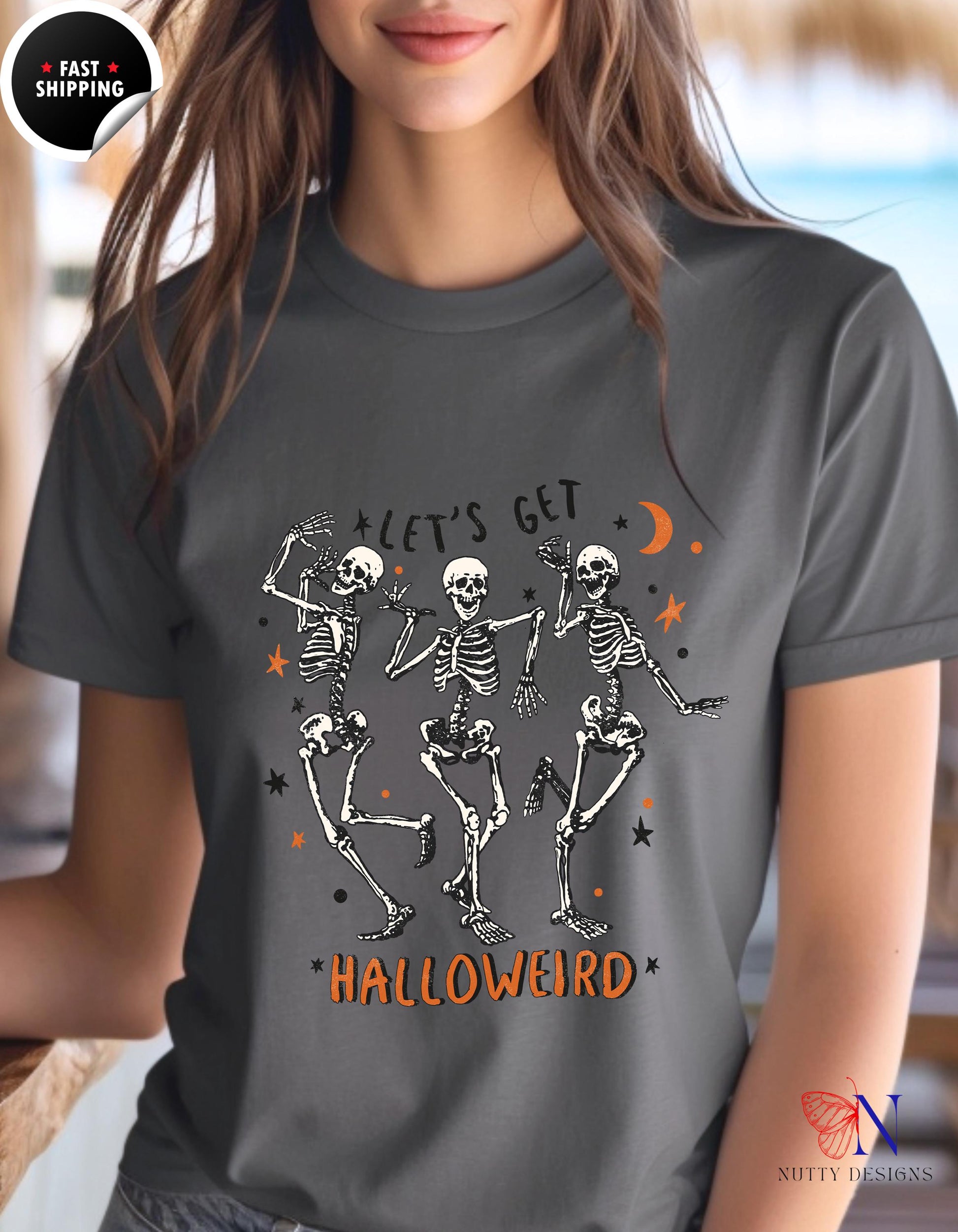 a woman wearing a halloween t - shirt with skeletons on it