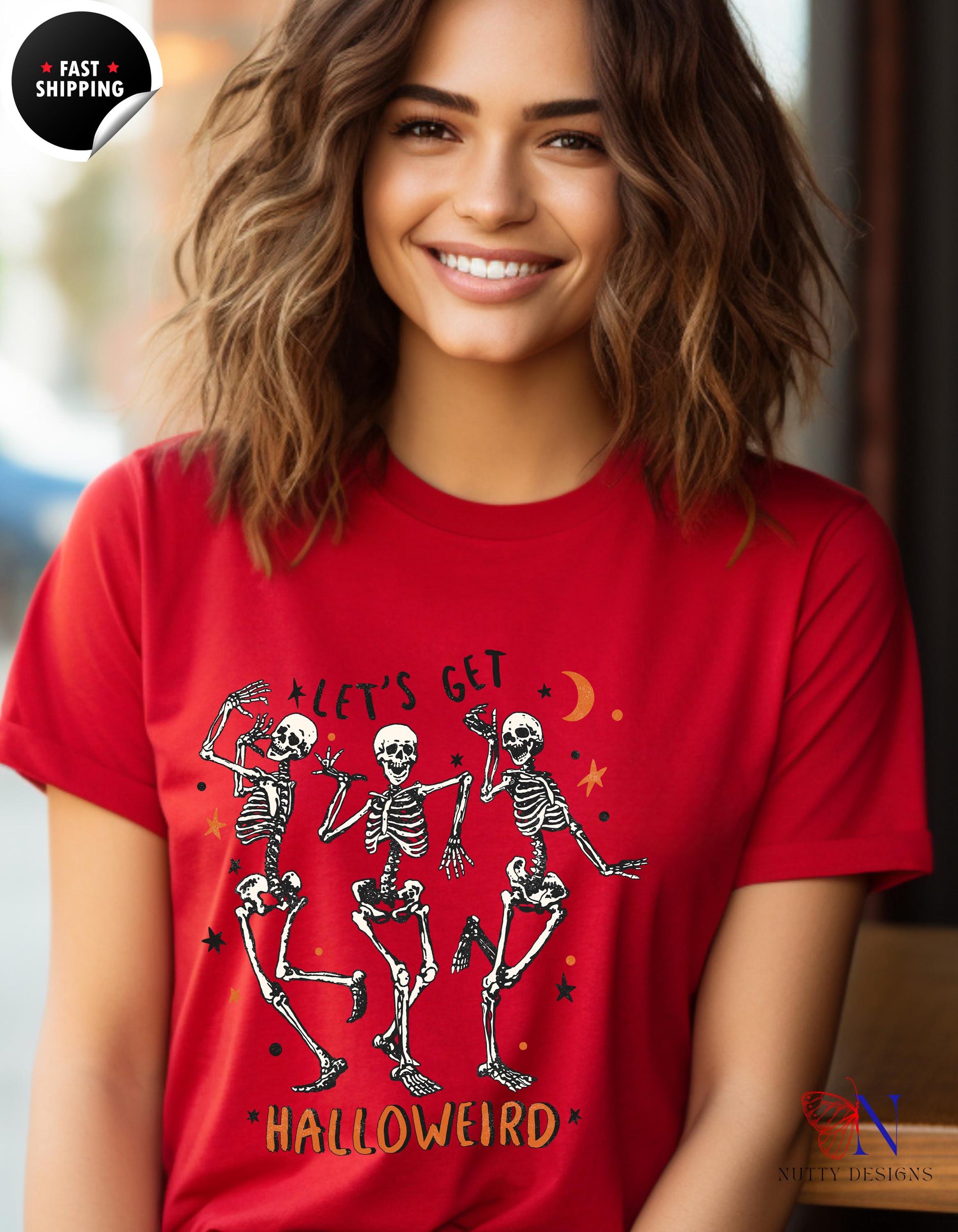 a woman wearing a red shirt with skeletons on it