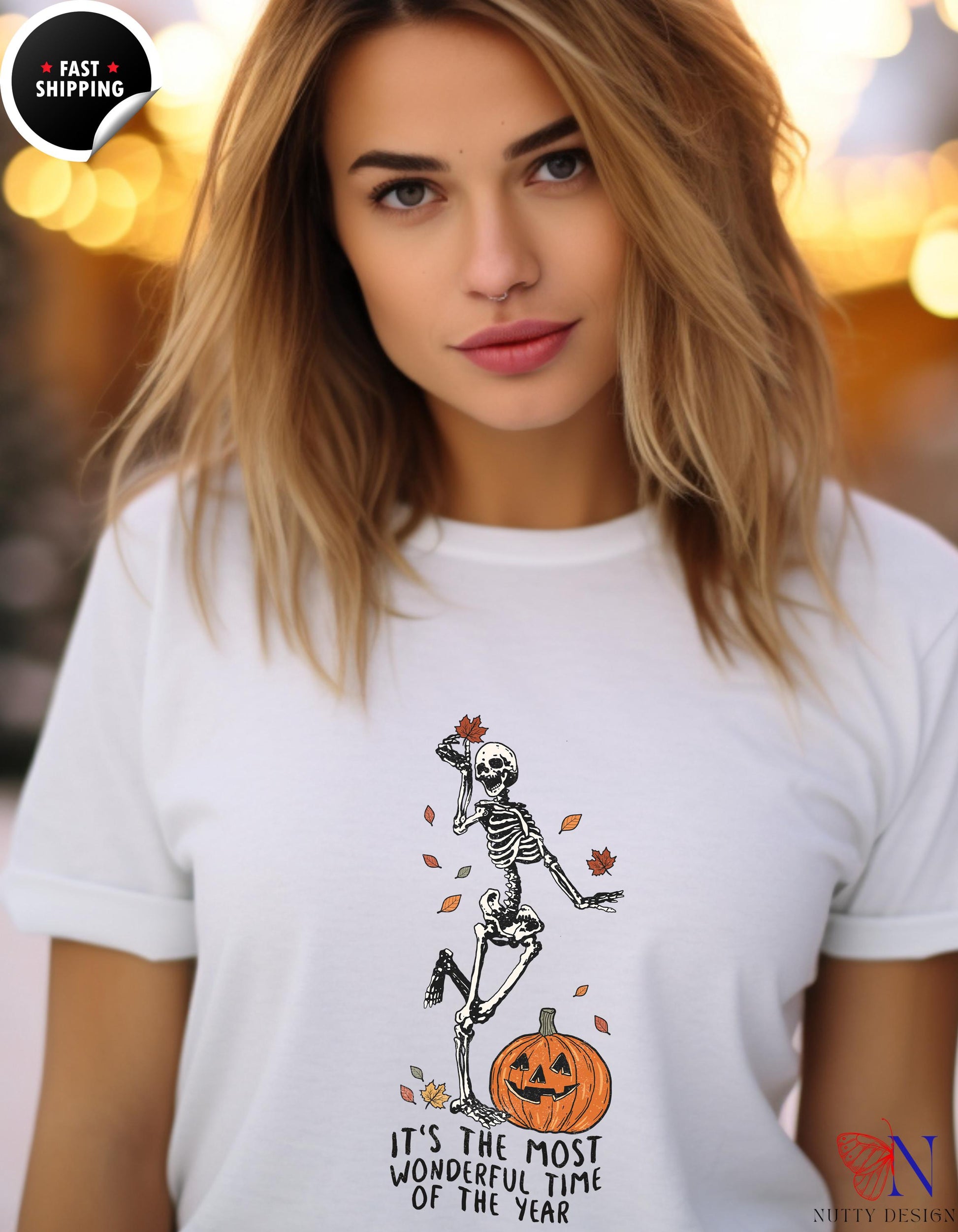 a woman wearing a white shirt with a skeleton on it