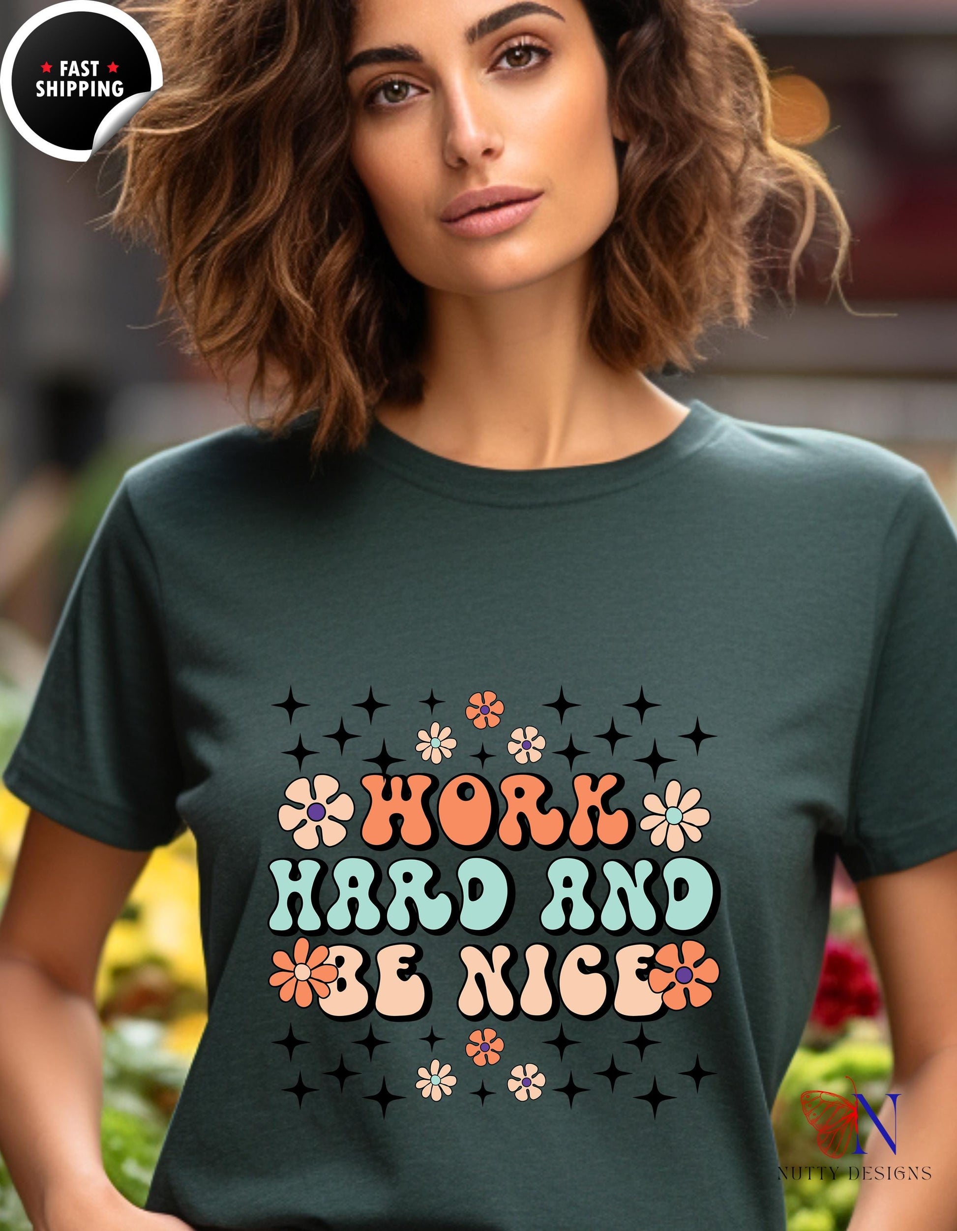 a woman wearing a t - shirt that says work hard and be nice