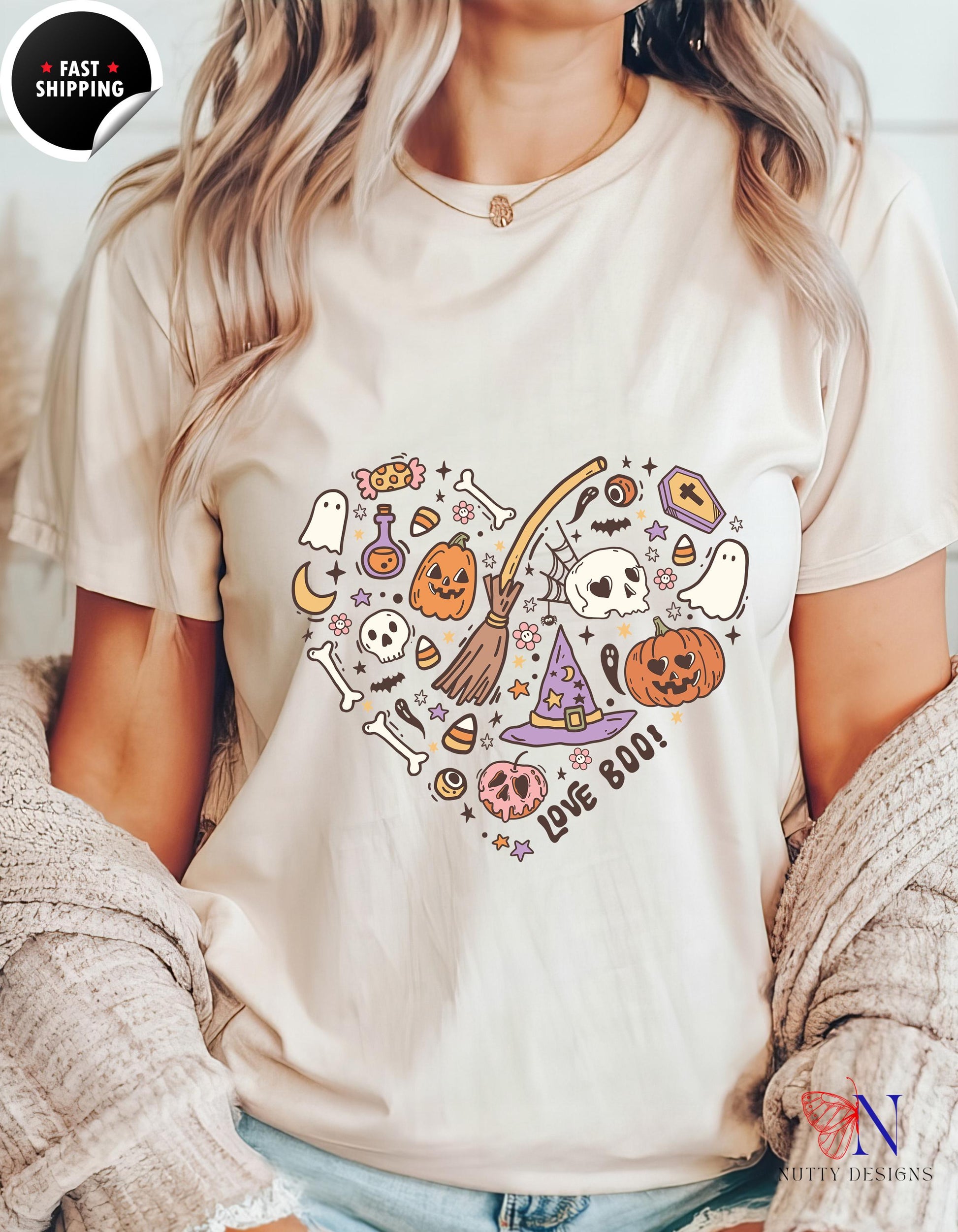 a woman wearing a white t - shirt with a heart shaped halloween design