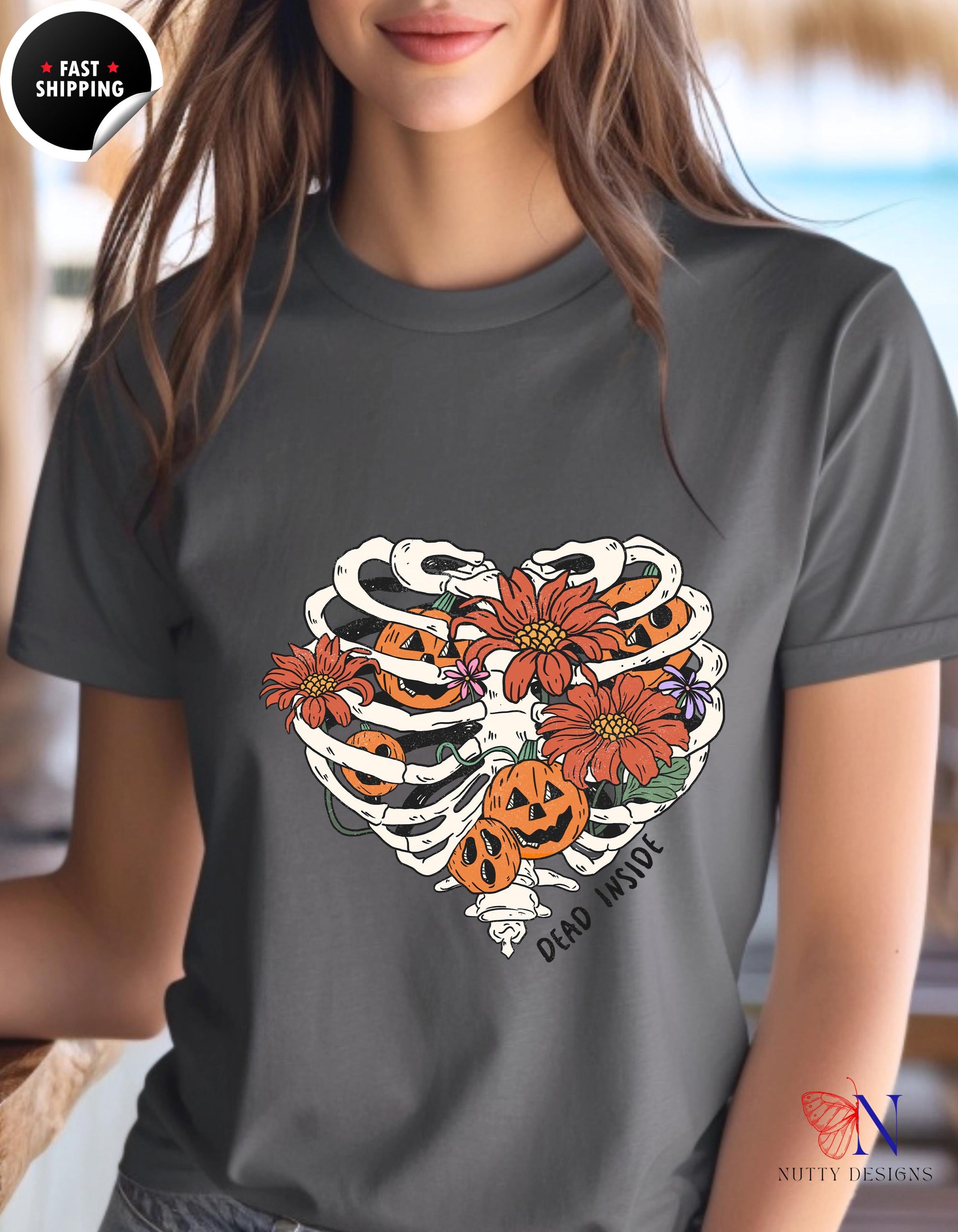 a woman wearing a t - shirt with a skeleton and flowers on it