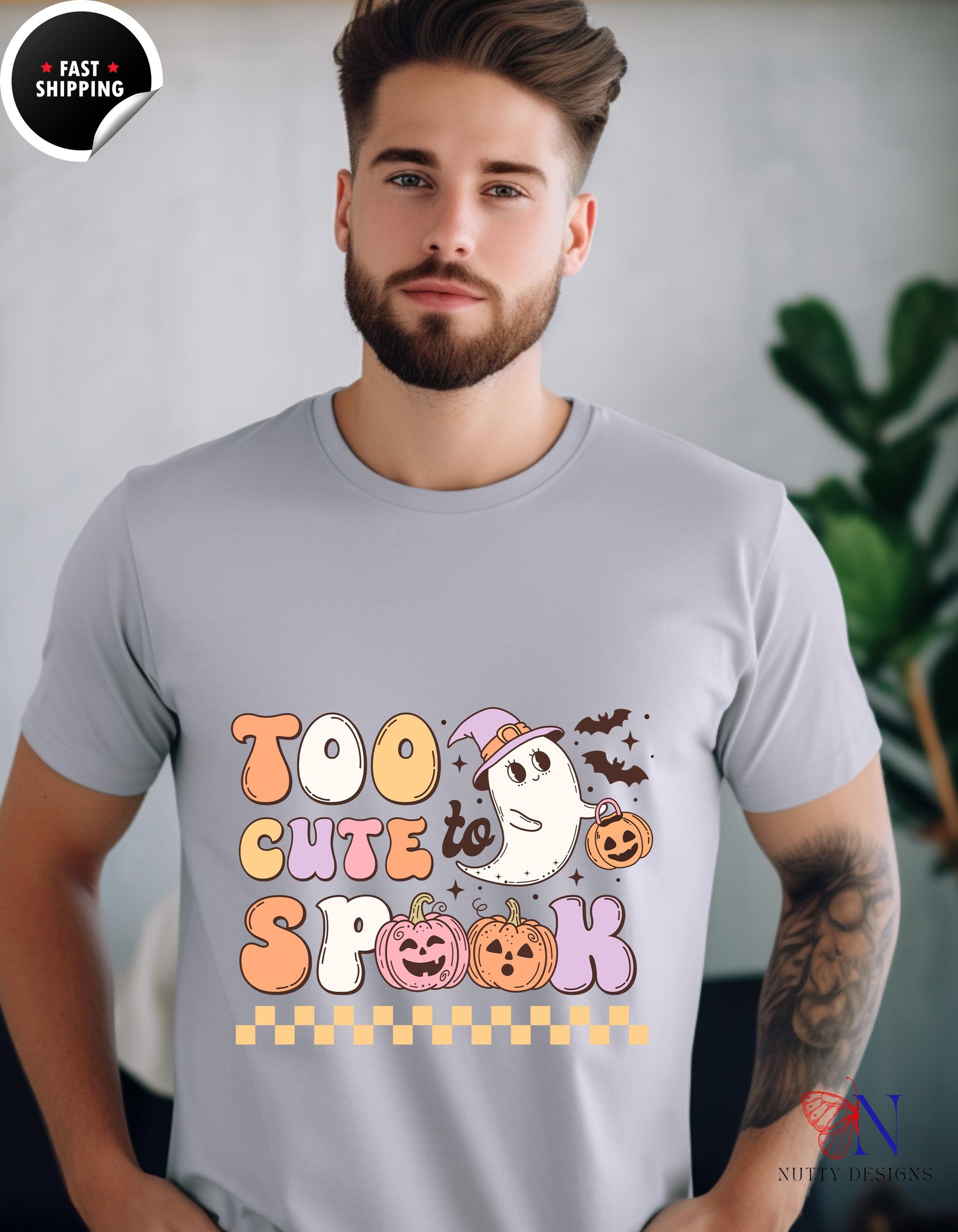 a man wearing a t - shirt that says too cute for halloween