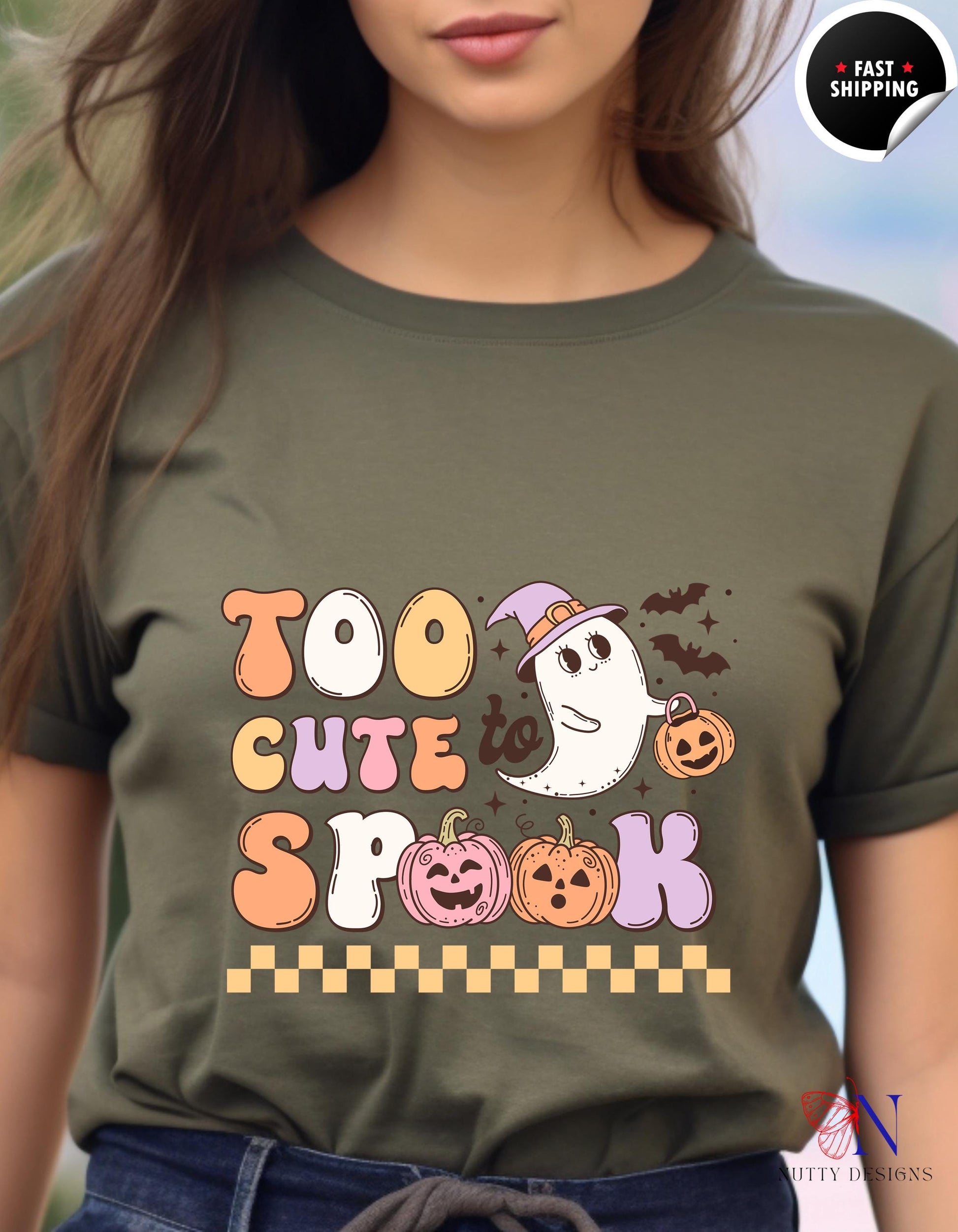 a woman wearing a t - shirt that says too cute for spook