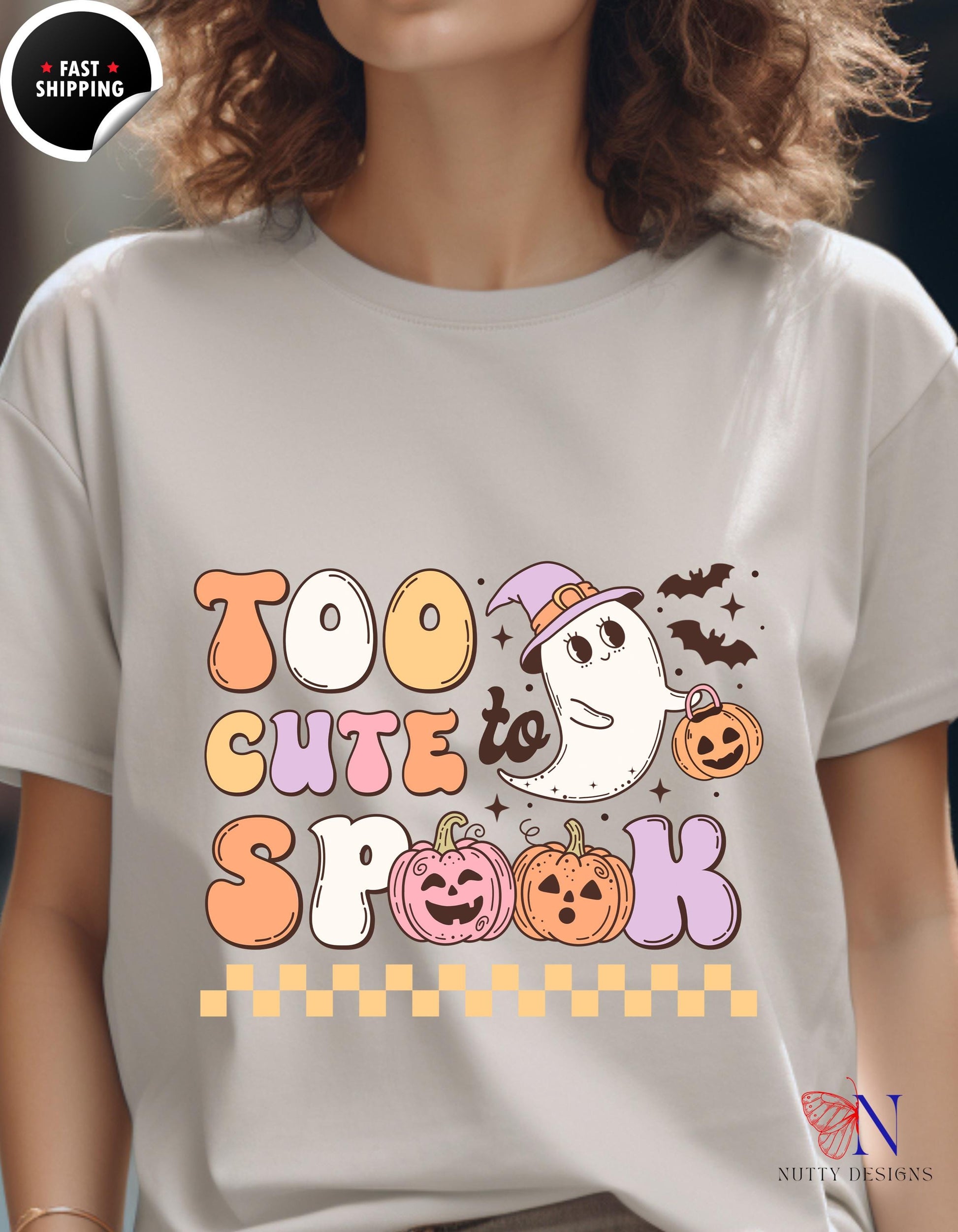 a woman wearing a t - shirt that says too cute to spook