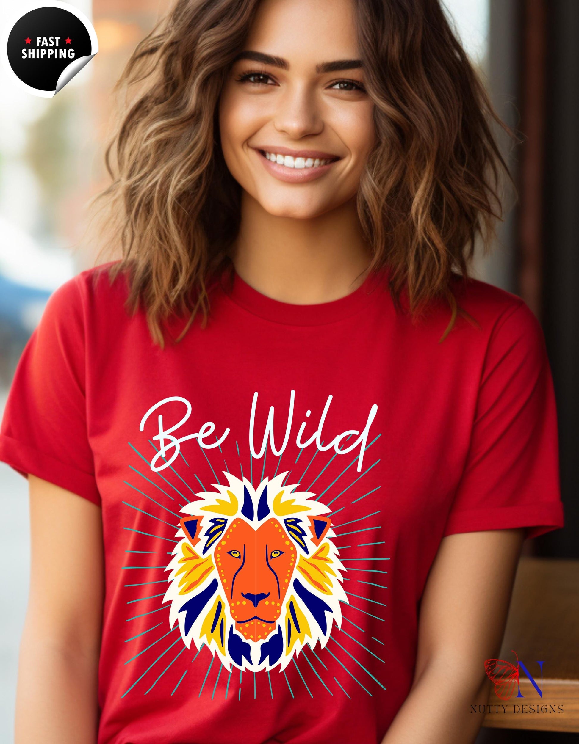 a woman wearing a red t - shirt with a lion on it