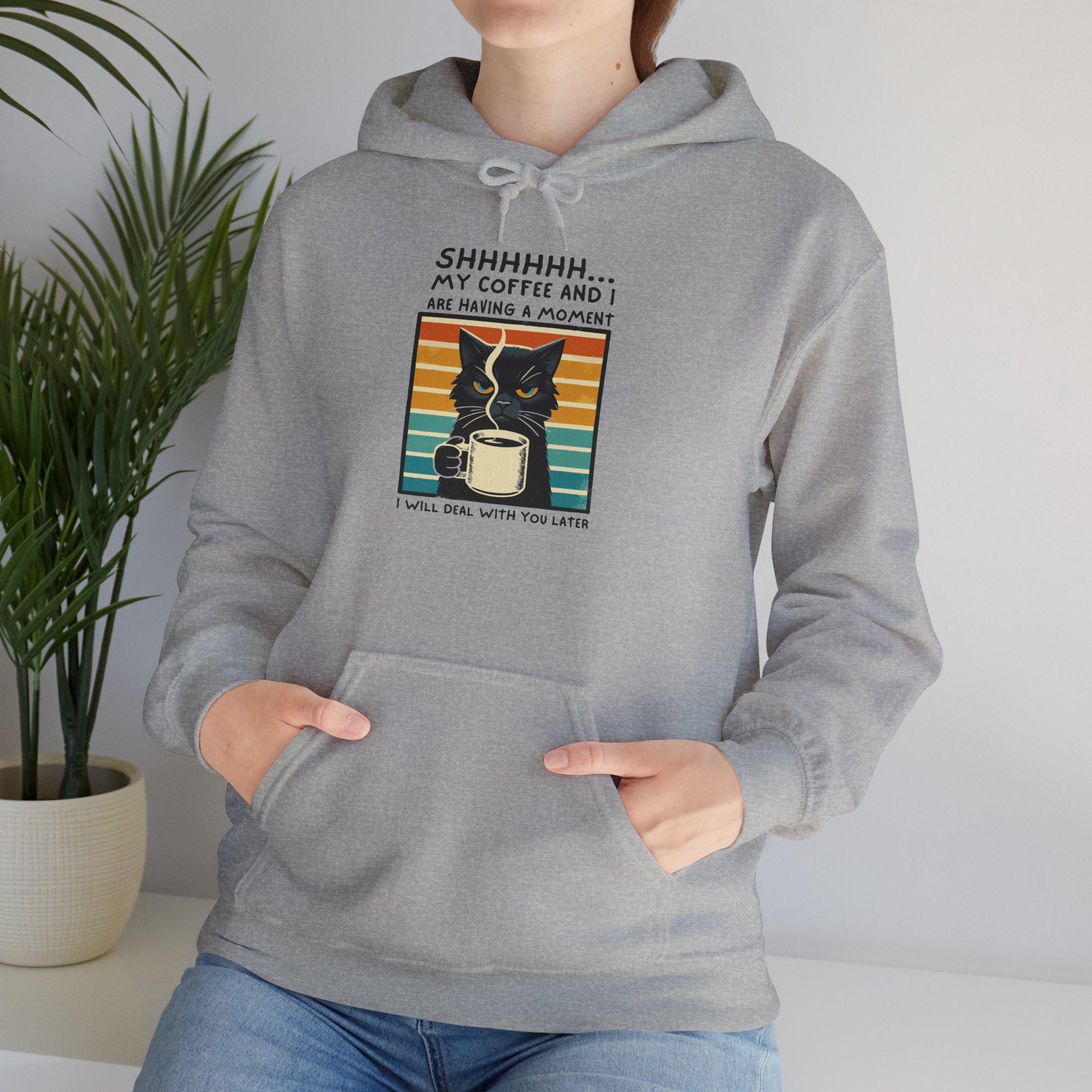 Funny unisex hoodie featuring a cat with coffee graphic, perfect for cozy days.