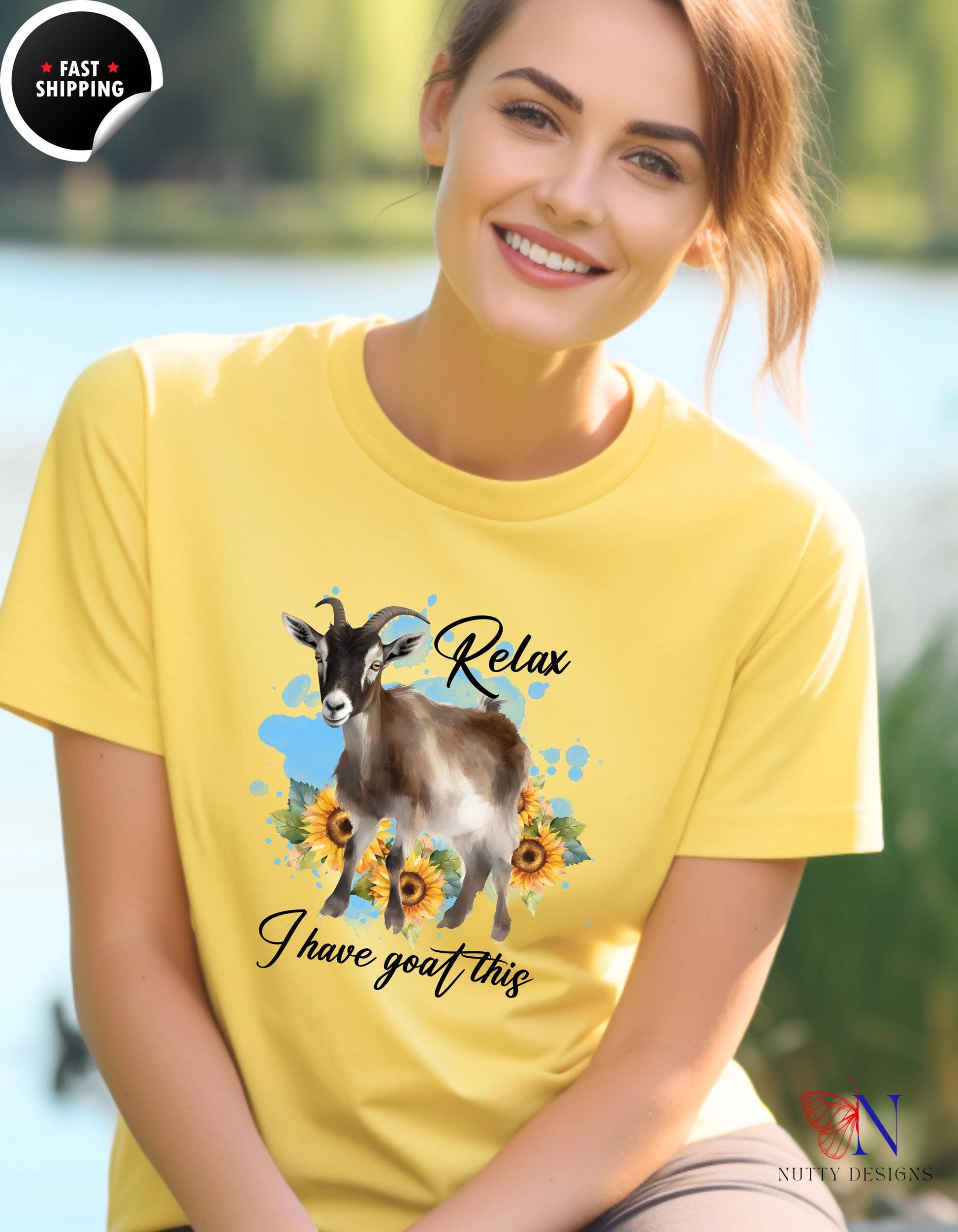 a woman wearing a yellow shirt with a goat on it