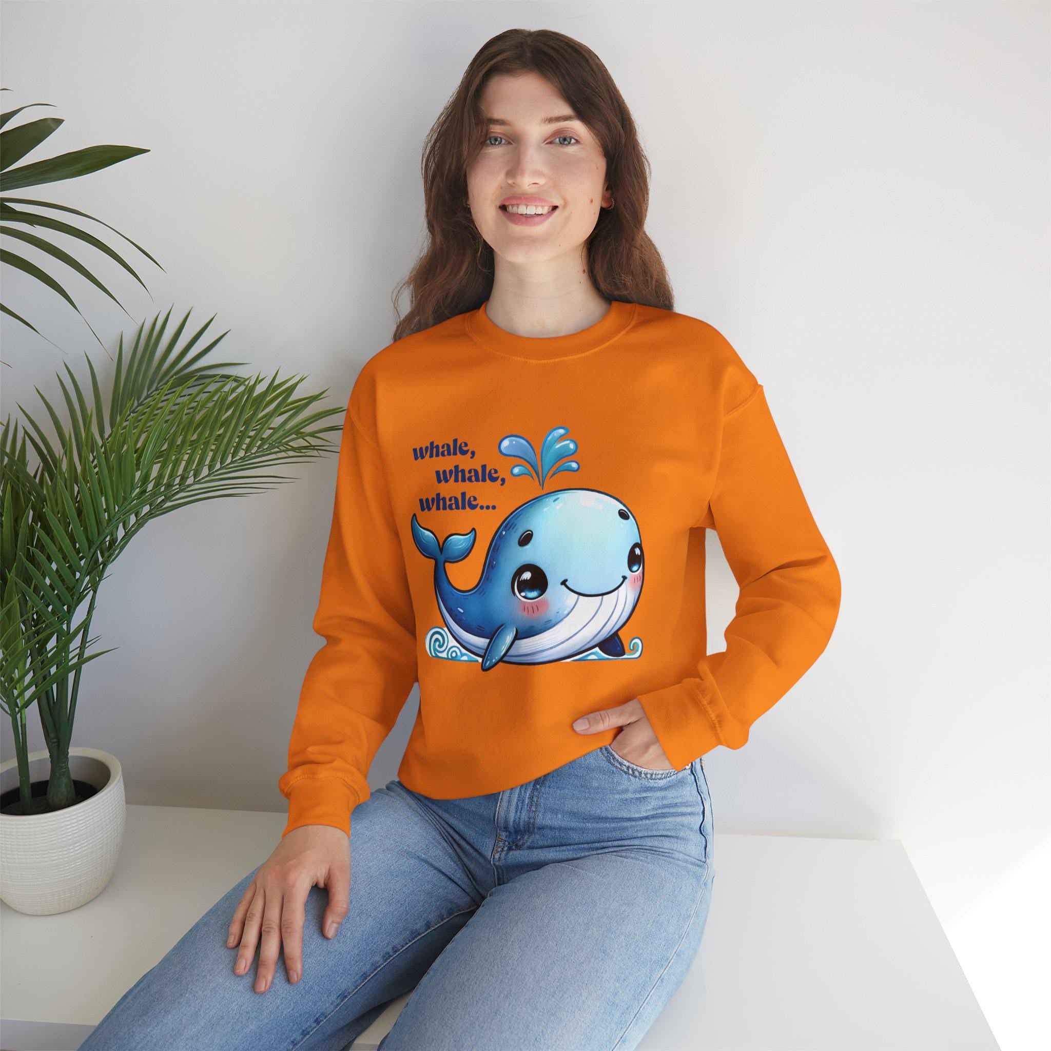 Smiling woman wearing an orange whale-themed sweatshirt, showcasing a cute graphic print for animal lovers.