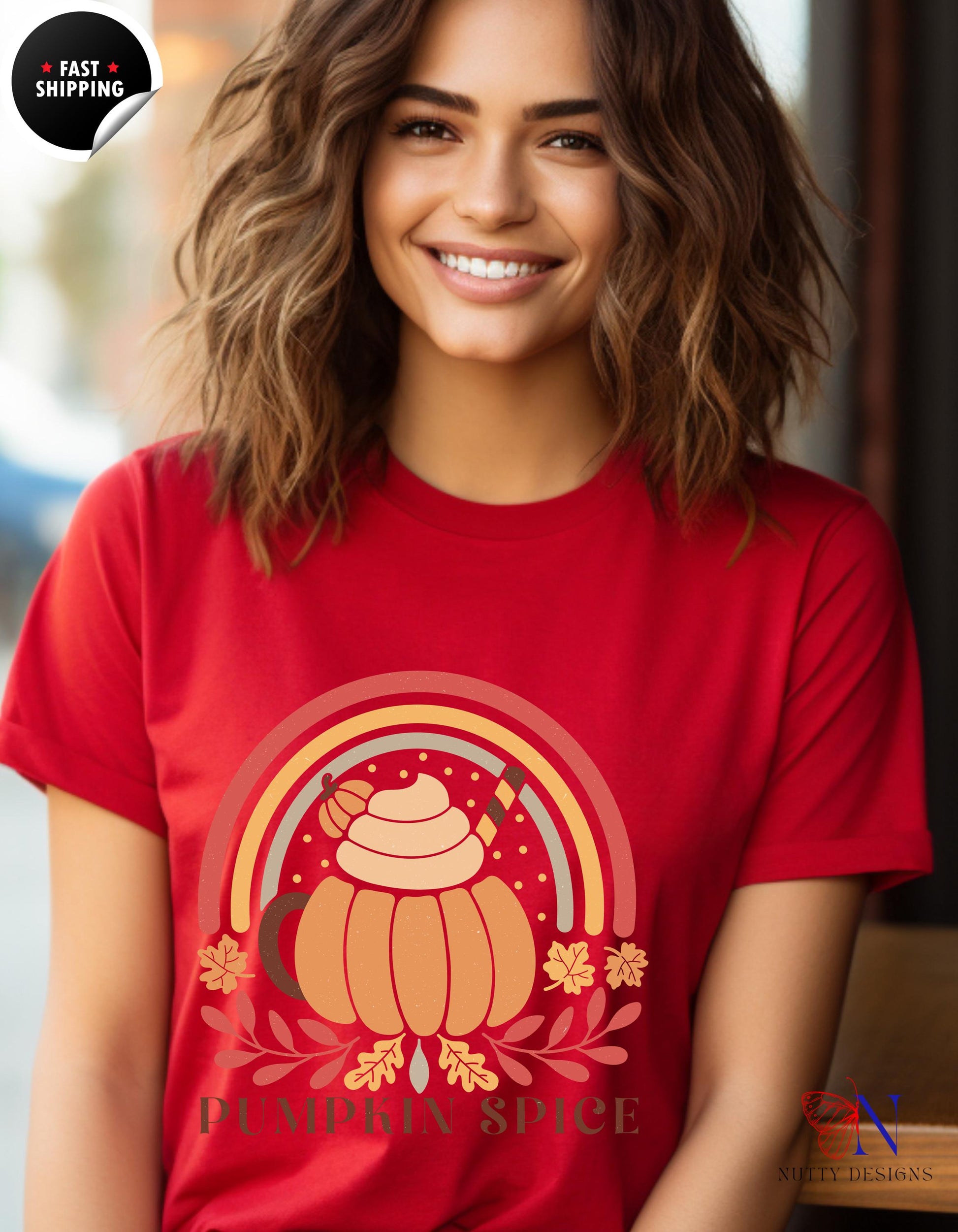 a woman wearing a red t - shirt with a picture of a pumpkin on it