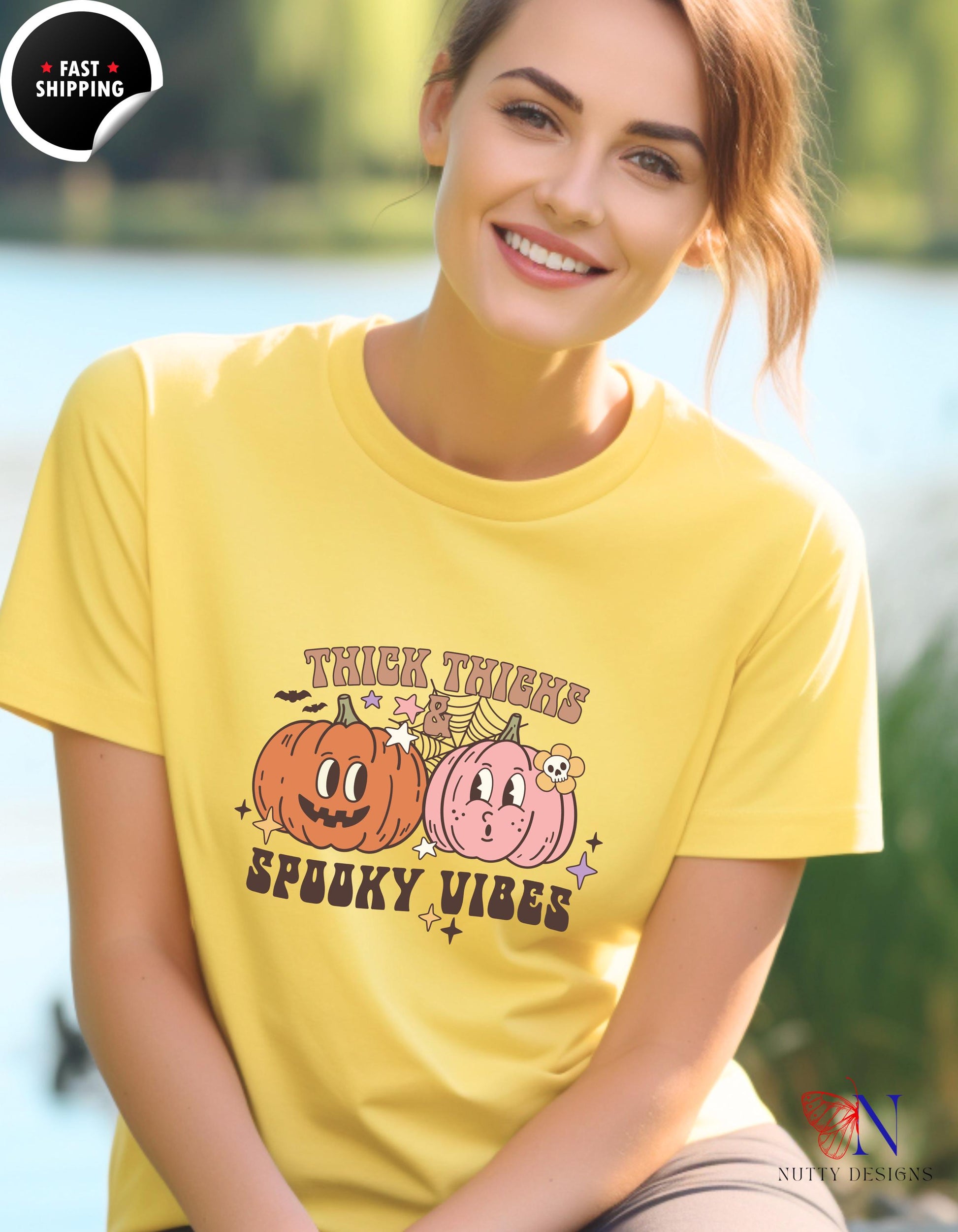 a woman wearing a yellow t - shirt with two pumpkins on it