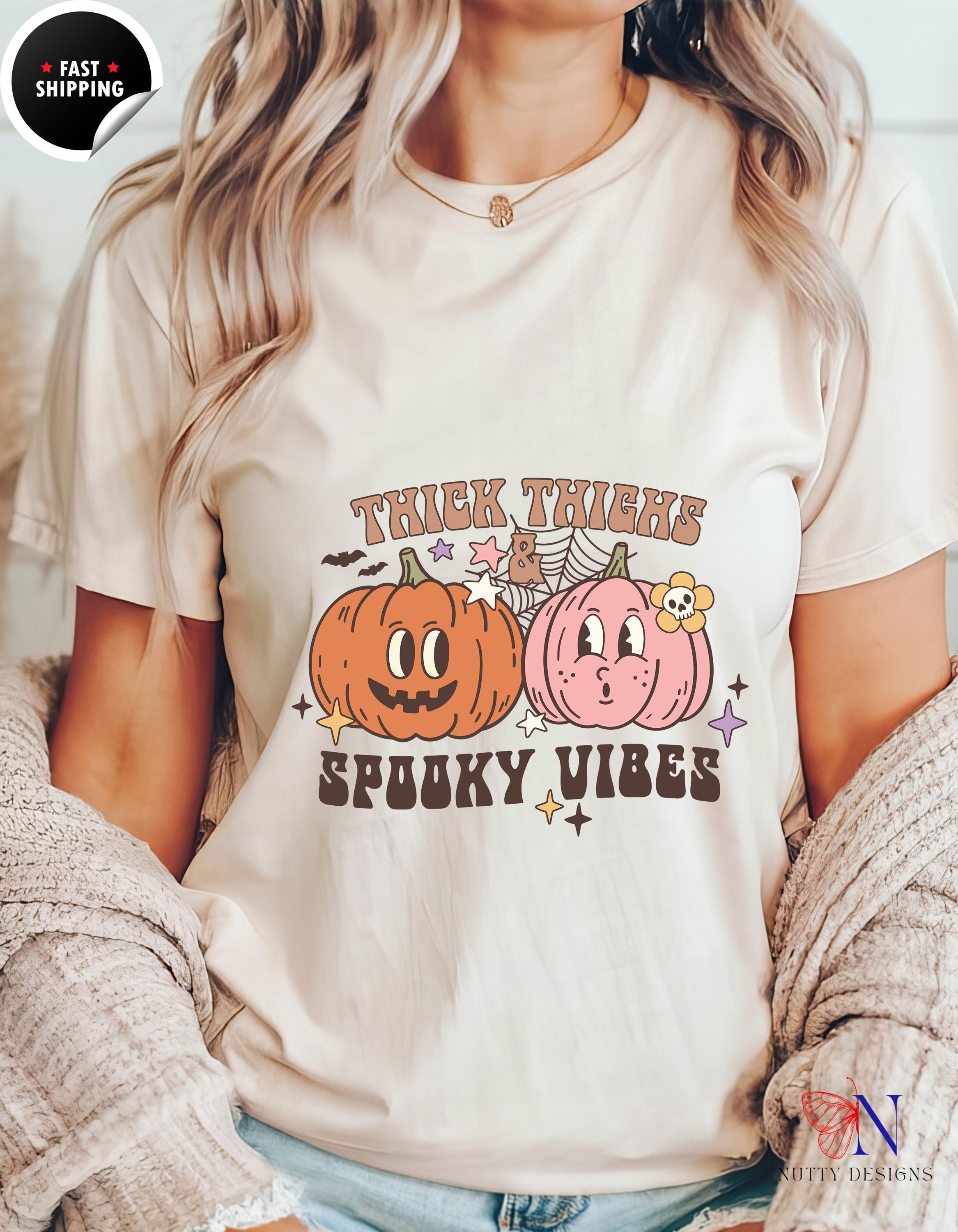 a woman wearing a t - shirt that says trick tricks spooky vibes