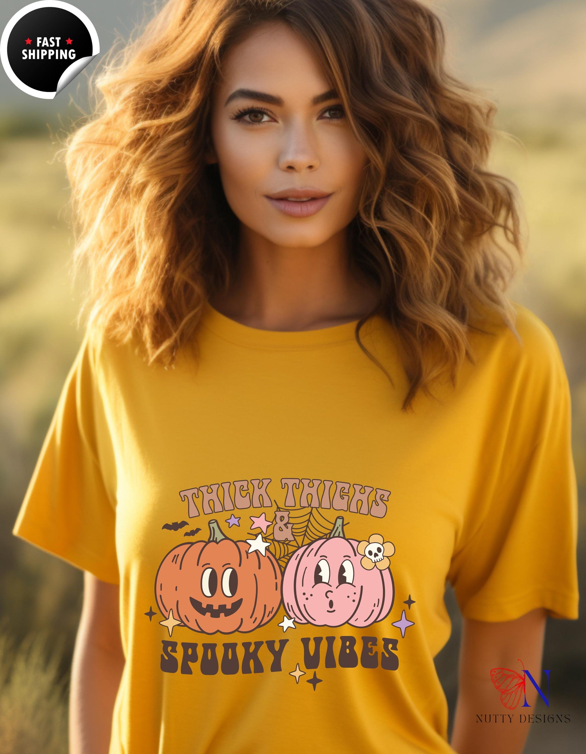 a woman wearing a yellow shirt with two pumpkins on it