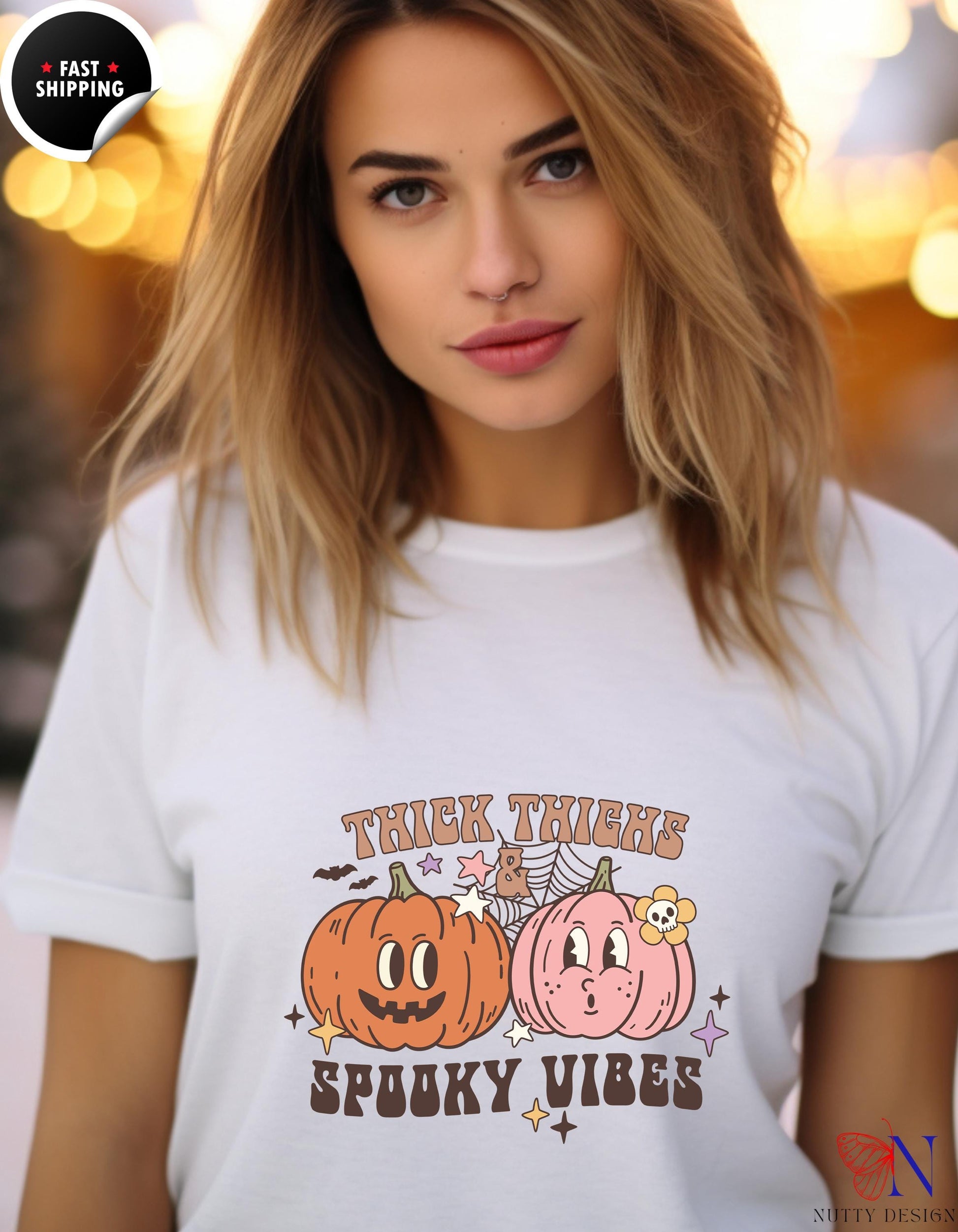 a woman wearing a t - shirt with two pumpkins on it