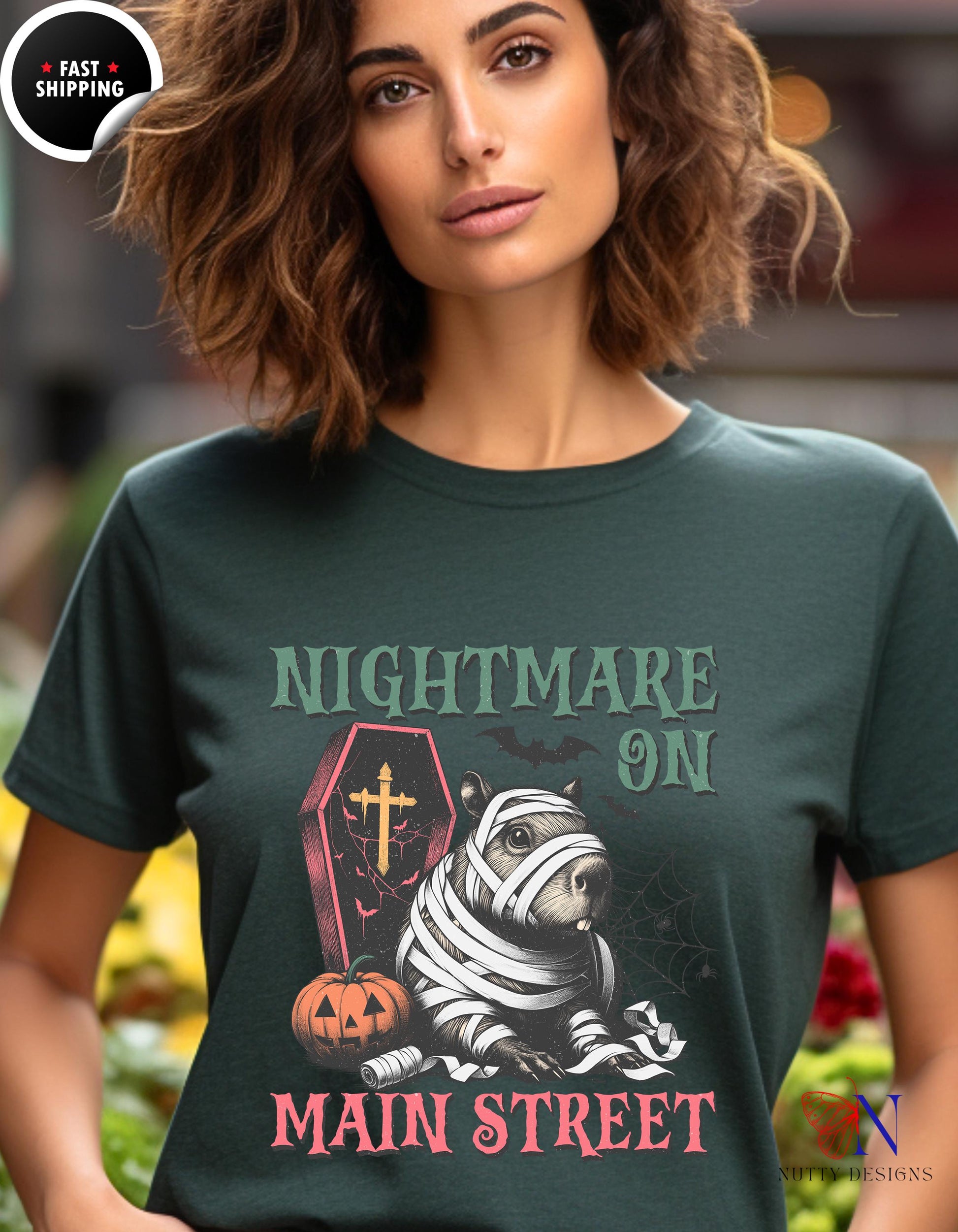 a woman wearing a t - shirt that says nightmares on main street