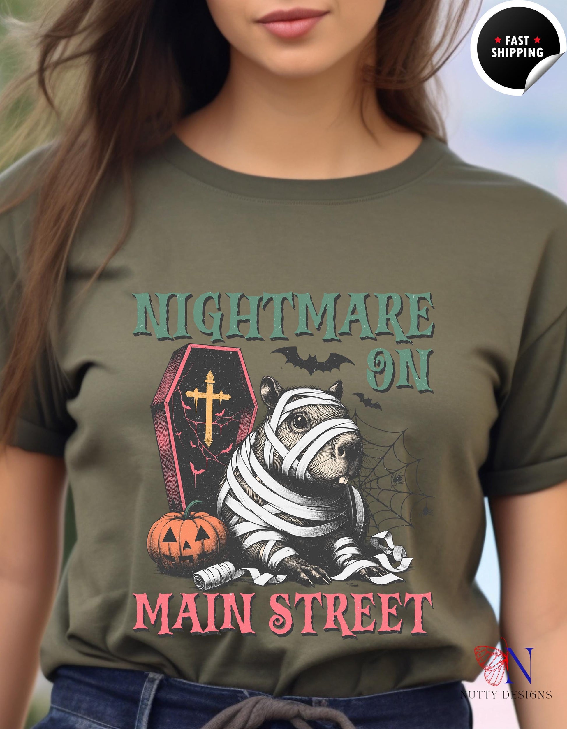 a woman wearing a t - shirt that says nightmares on main street