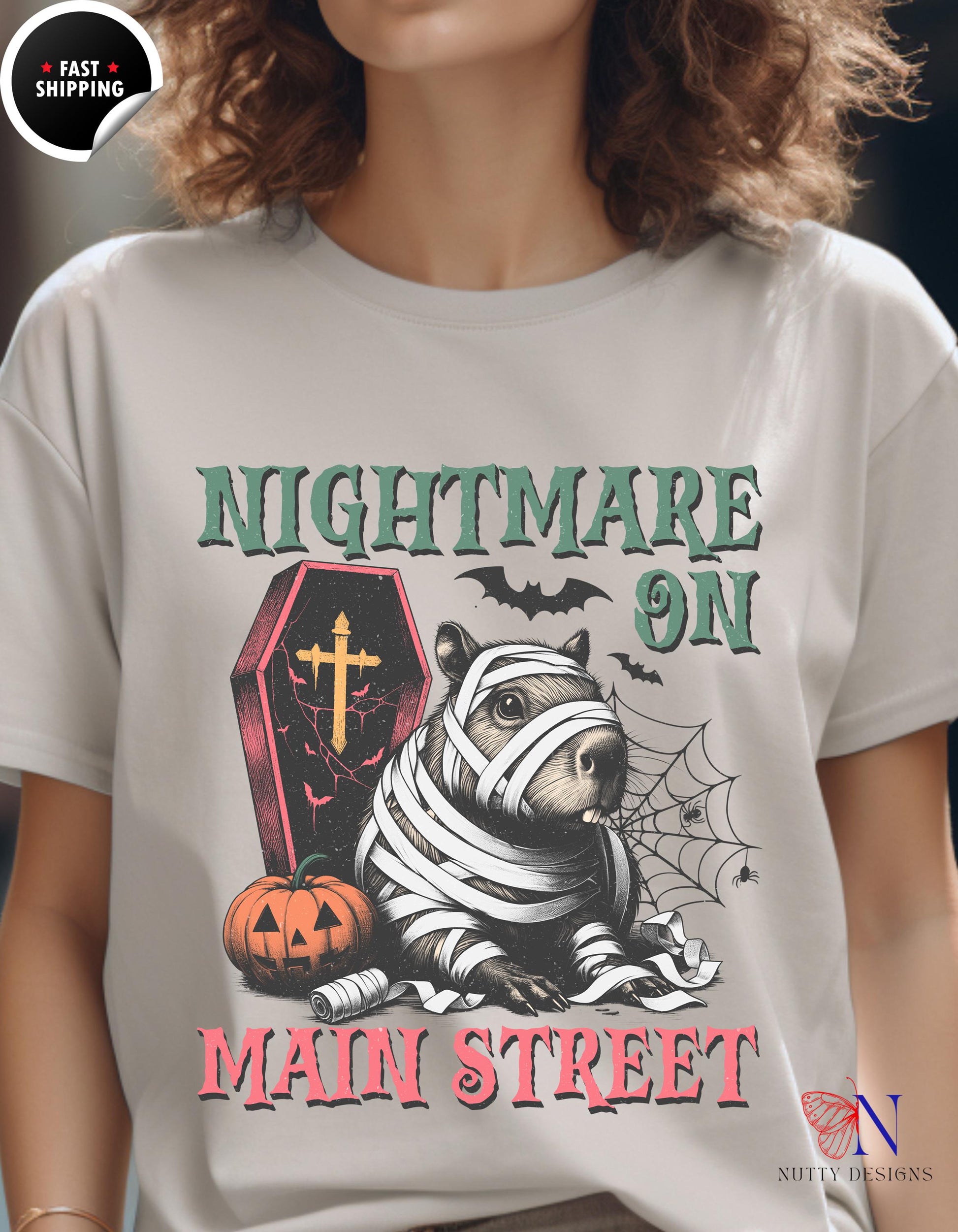 a woman wearing a white t - shirt that says nightmares on main street