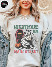 a woman wearing a shirt that says nightmares on main street